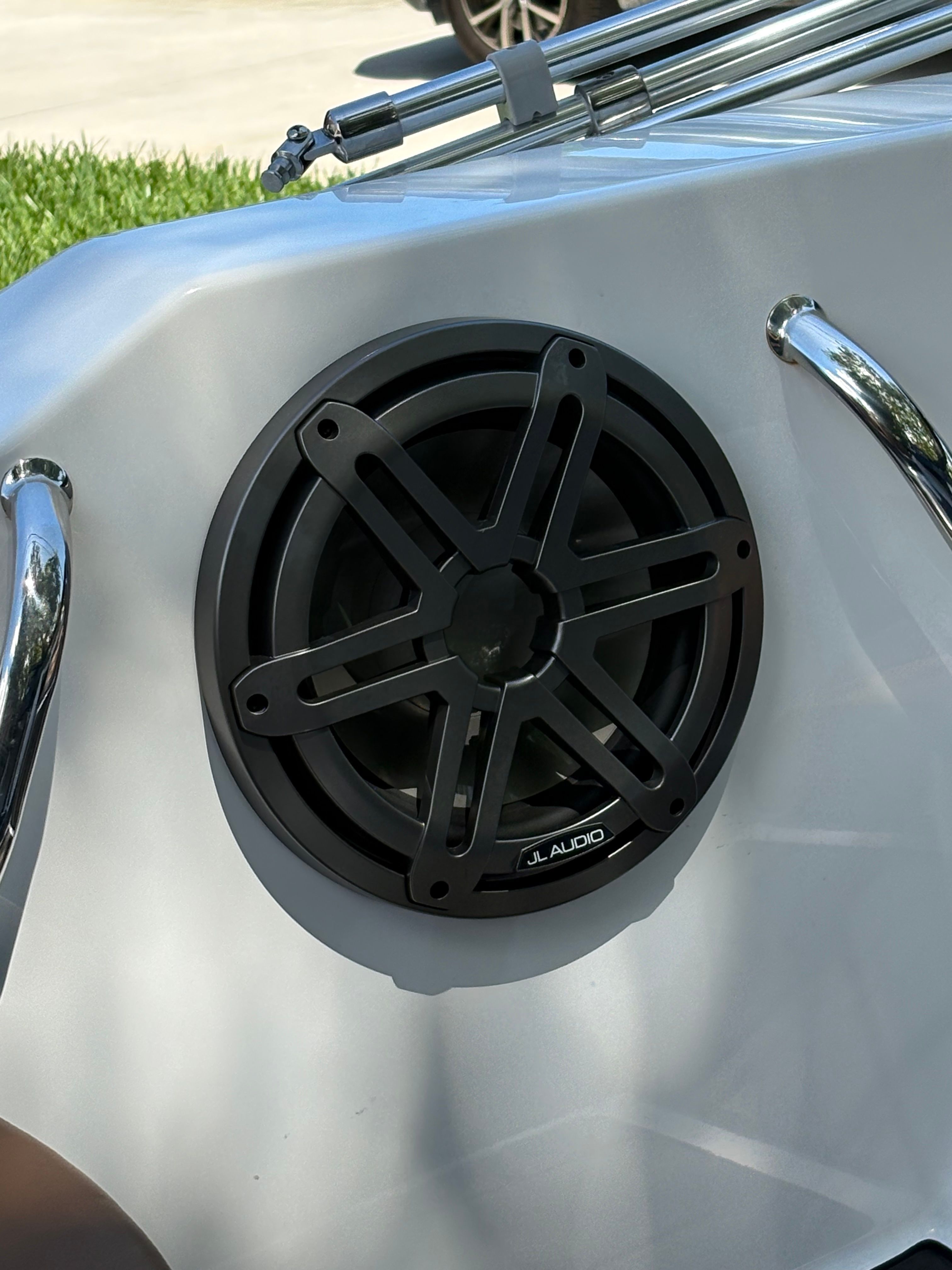 A JL Audio speaker is installed in a white boat.