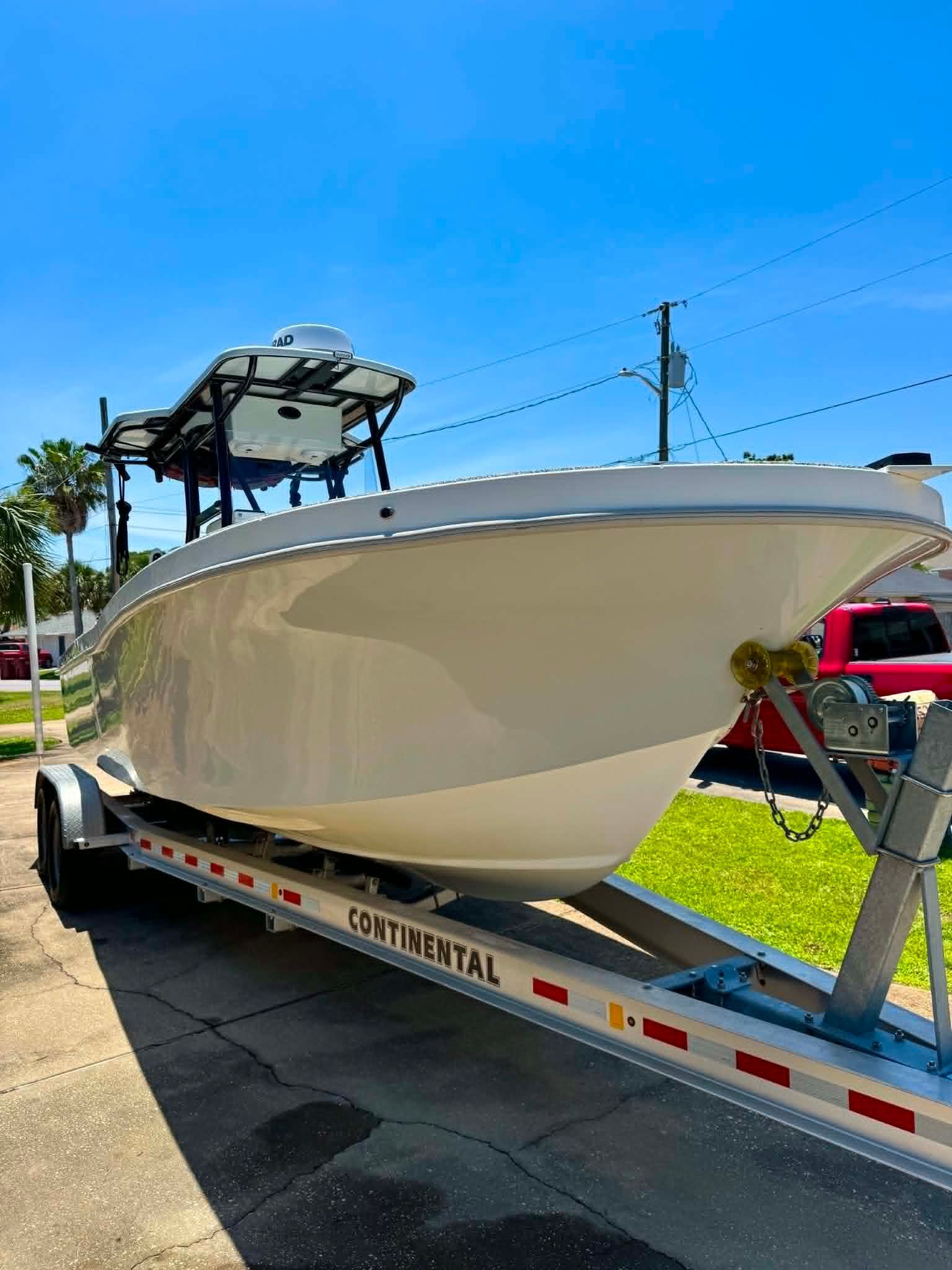 2023 Dusky 278 XFT boat on trailer in sunny weather.