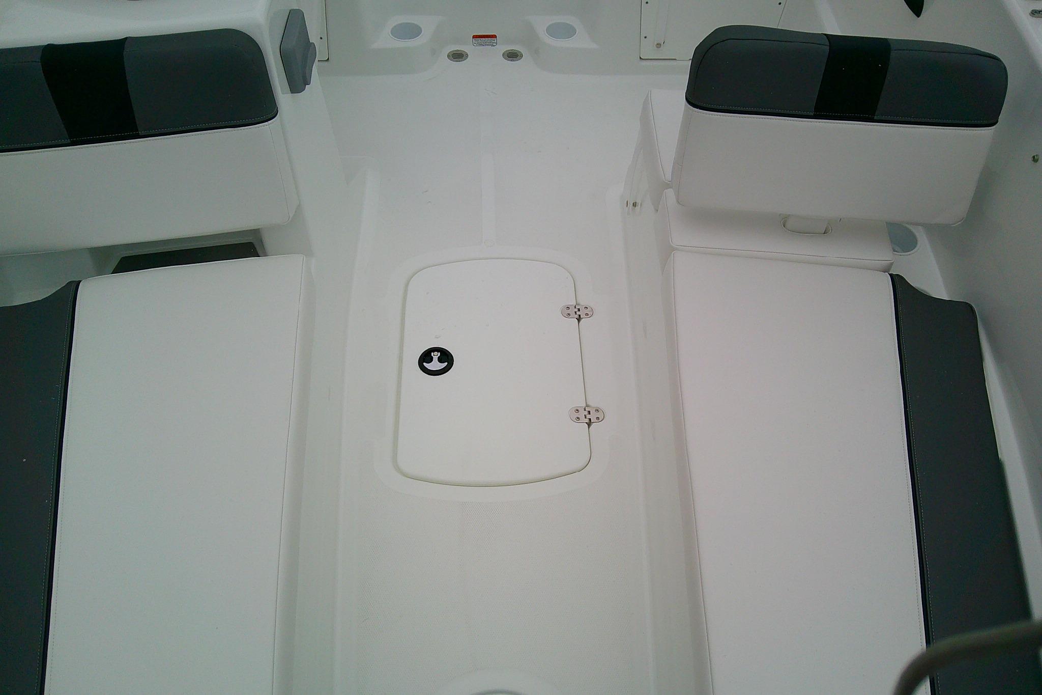 2026 Tahoe T18 boat interior with white seating and storage compartment.