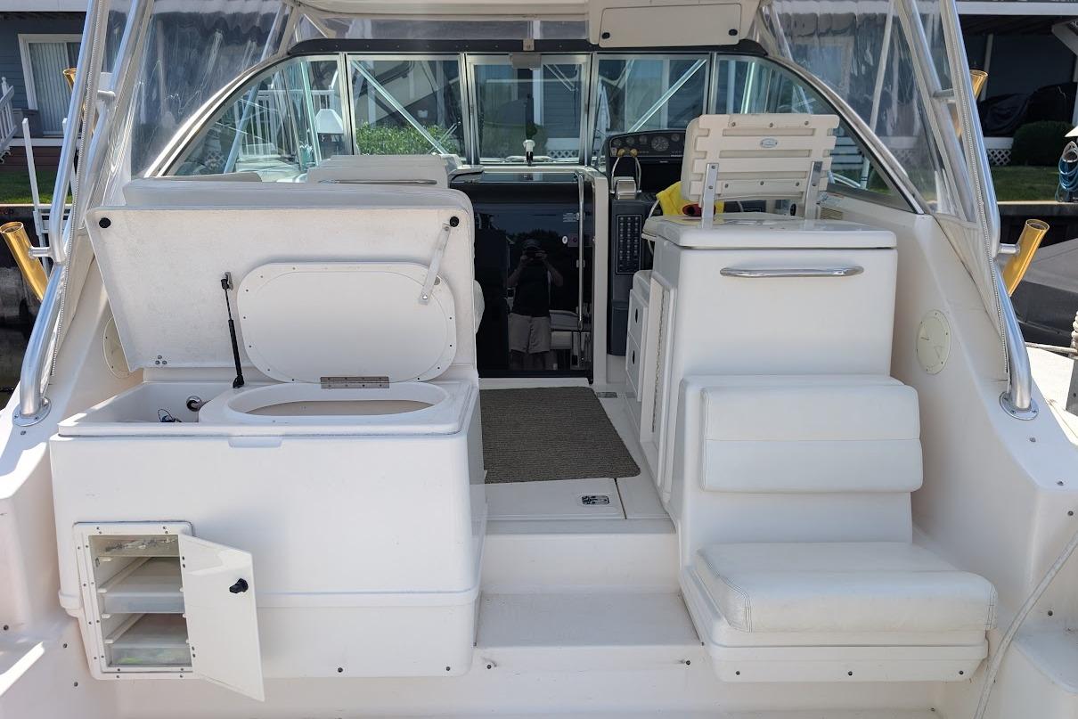 2000 Pursuit 3400 Express boat interior with seating, storage, and helm area.