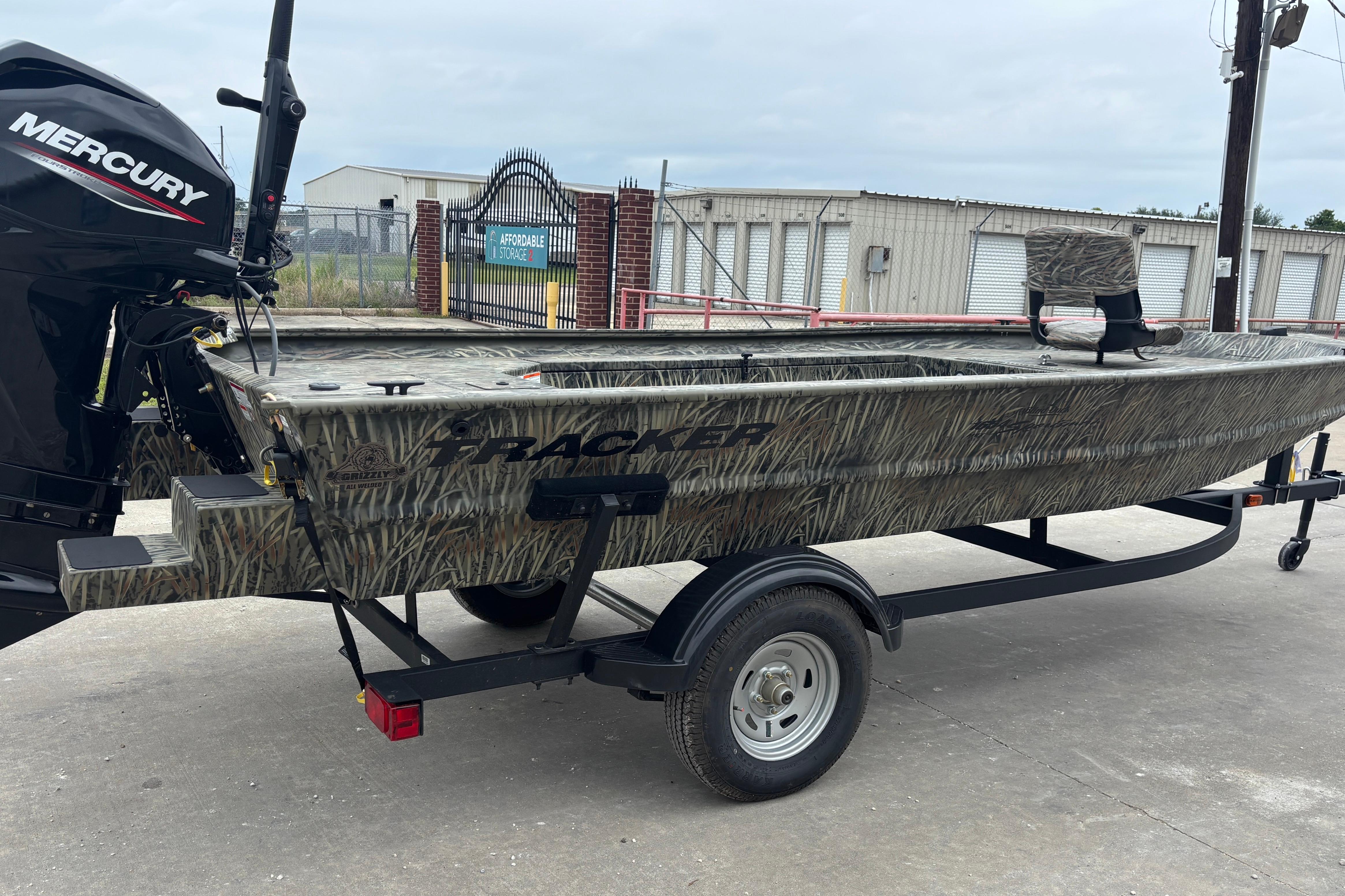 2026 Tracker Grizzly 1654 T Sportsman boat with Mercury engine on trailer.