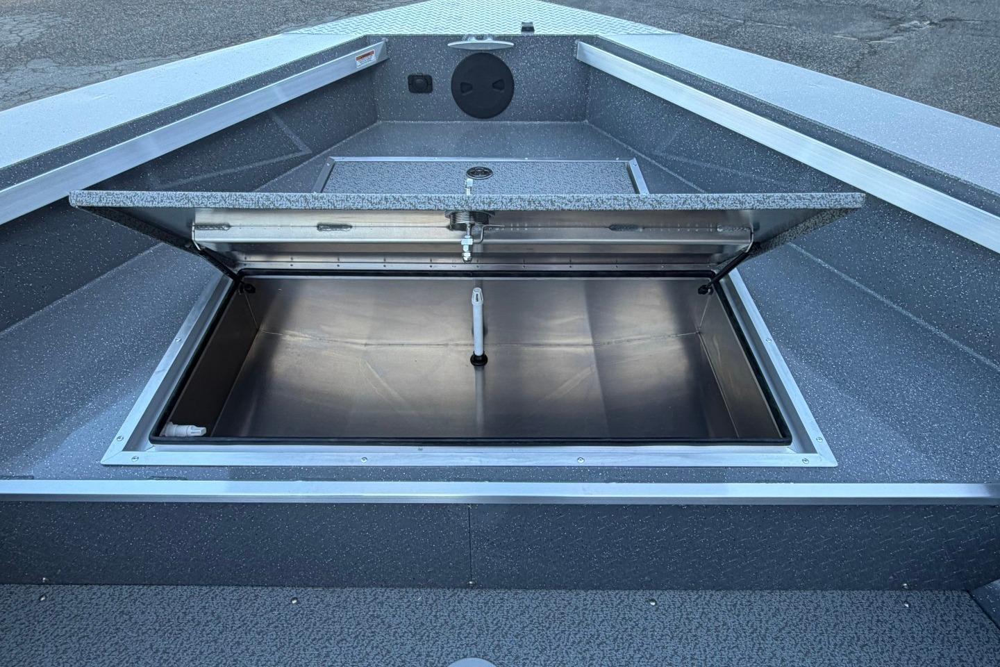 Open storage compartment on 2026 Thunder Jet 209 Rush OT boat, showcasing sleek interior design.