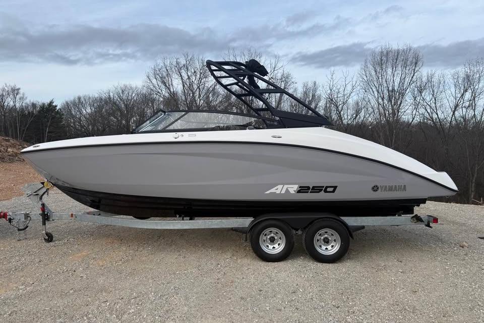 2026 Yamaha Boats AR250 on trailer, parked outdoors with trees in background.