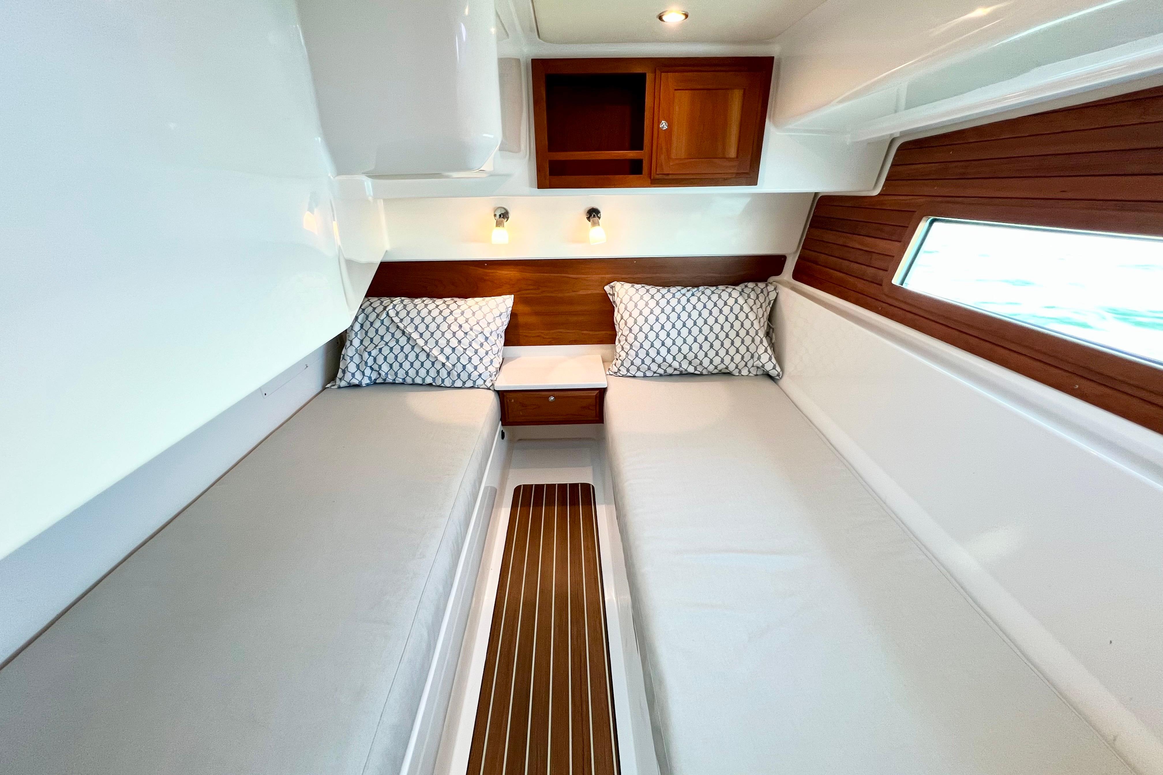 2021 Back Cove 390 cabin interior with twin beds, wooden accents, and modern lighting.