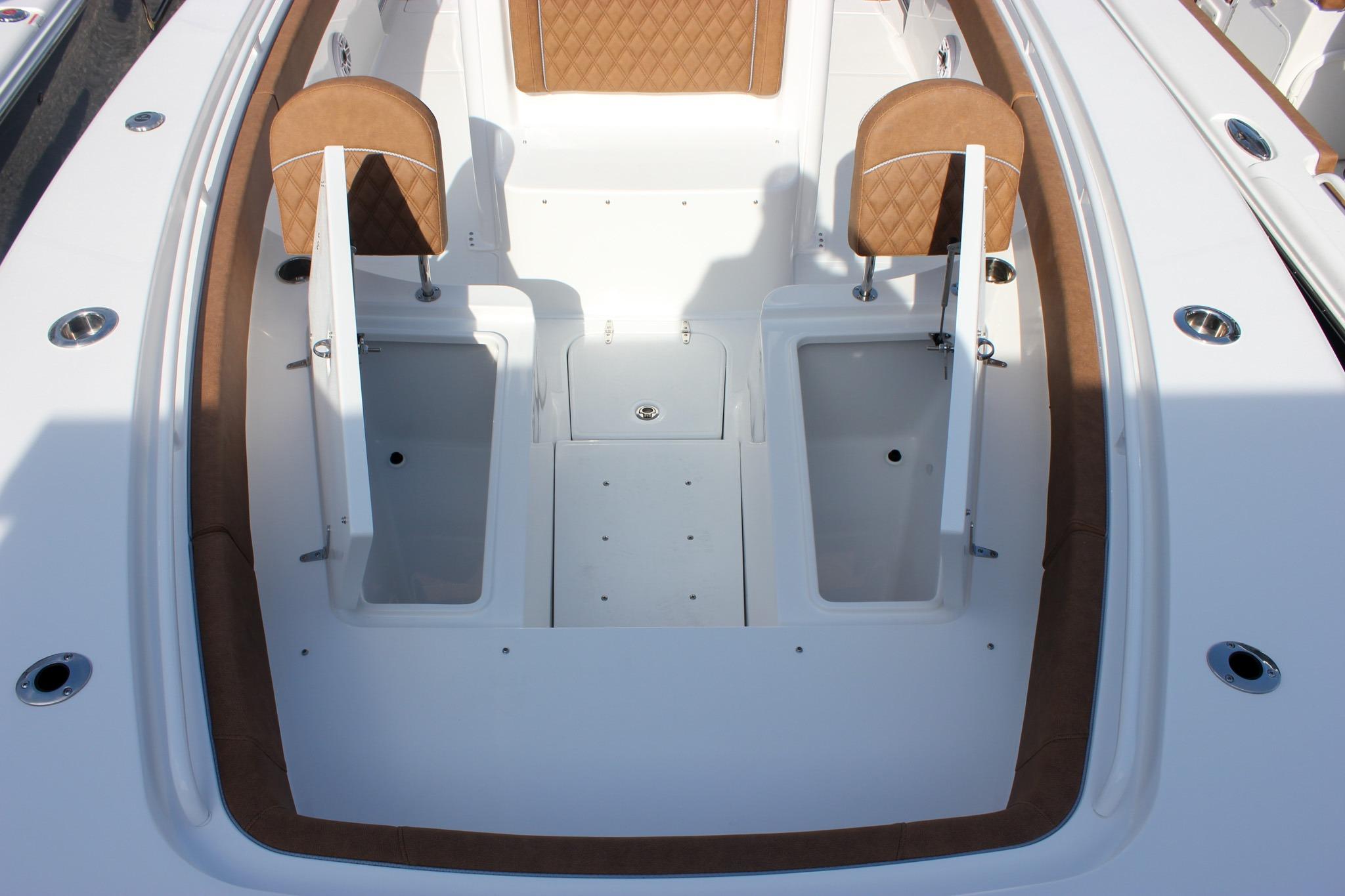 2027 Sea Hunt Ultra 275 SE boat interior with storage compartments and cushioned seating.