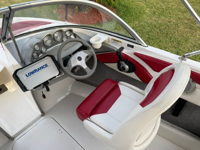 Interior of a 2012 Bayliner 184 SF with red and white seating.