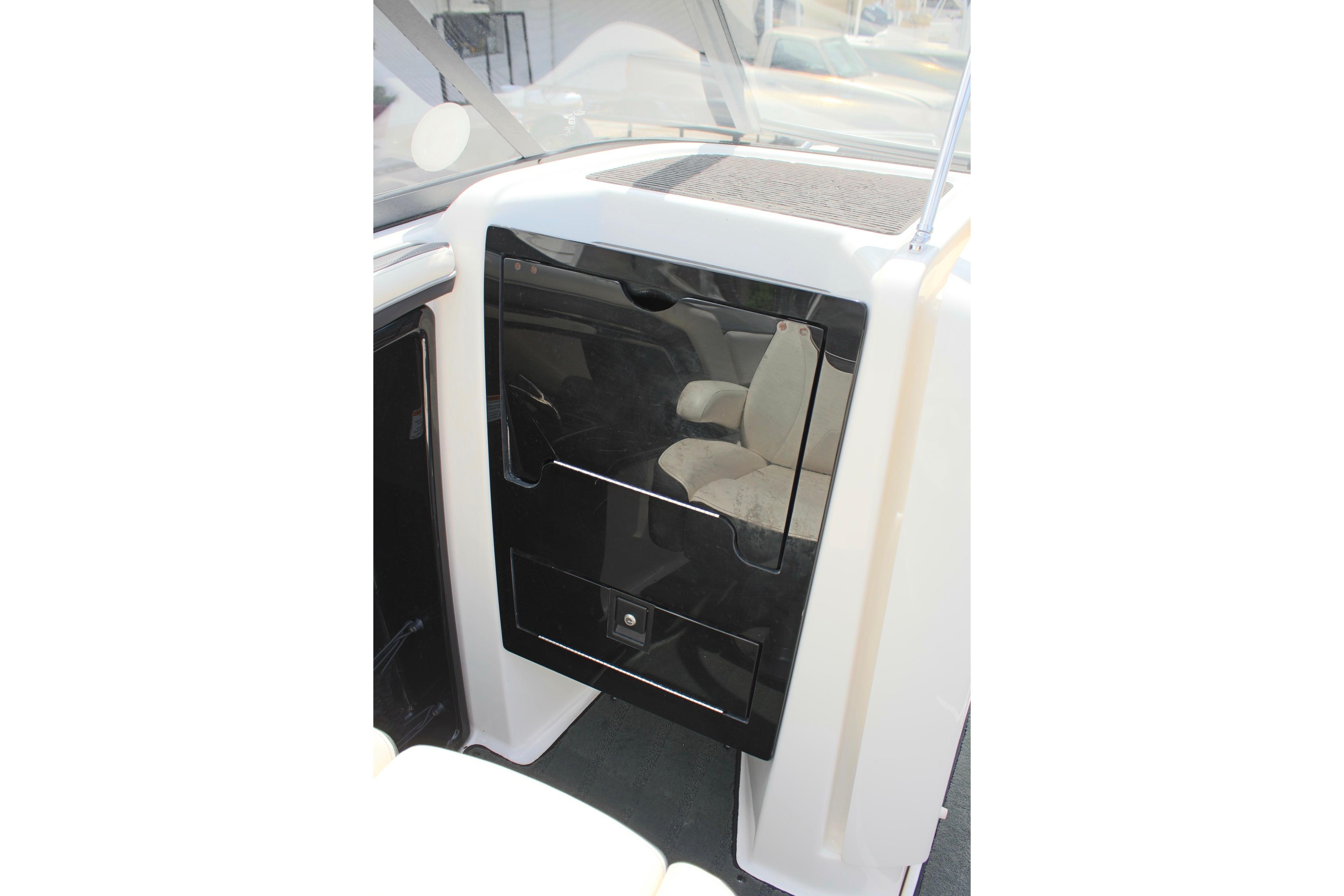2016 Yamaha Boats 242 Limited S cabin entrance with sleek black door design.