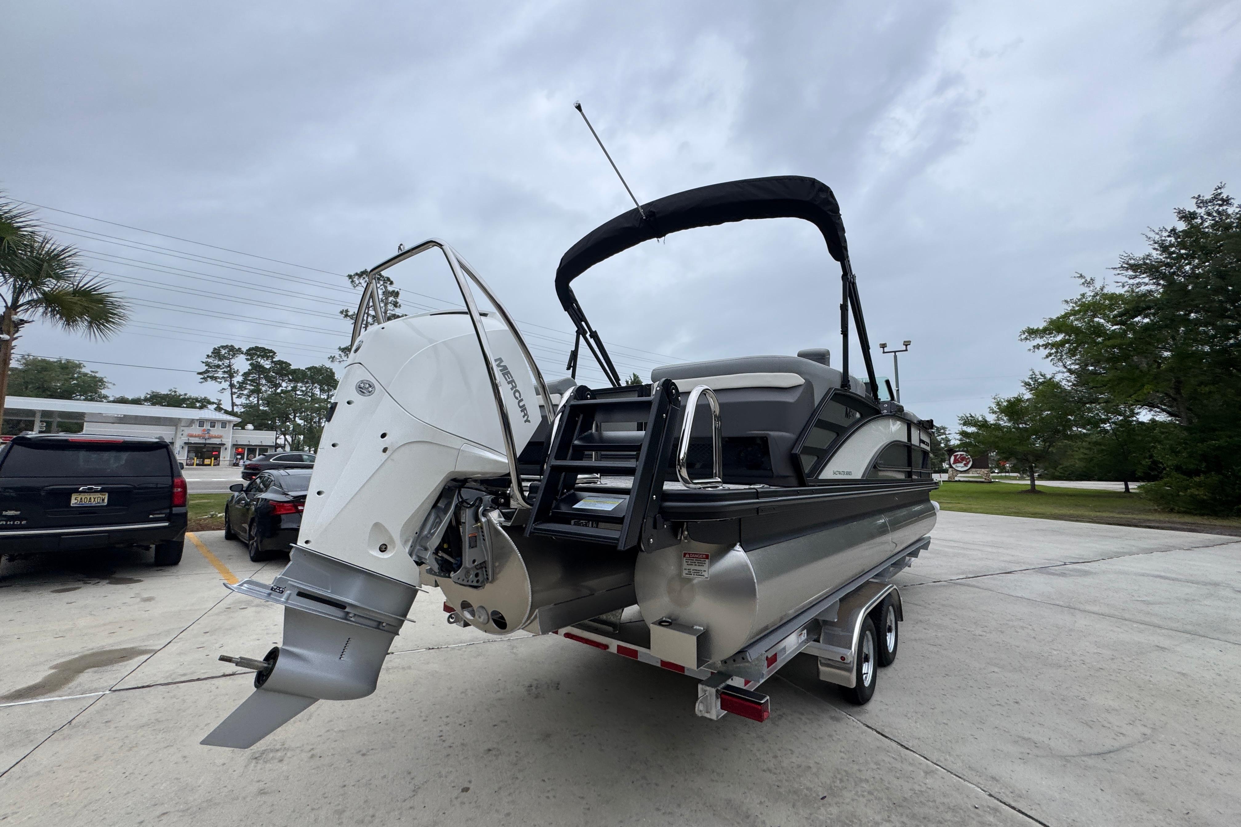 2027 Bennington 24 MFB boat on trailer, featuring a powerful Mercury outboard motor.