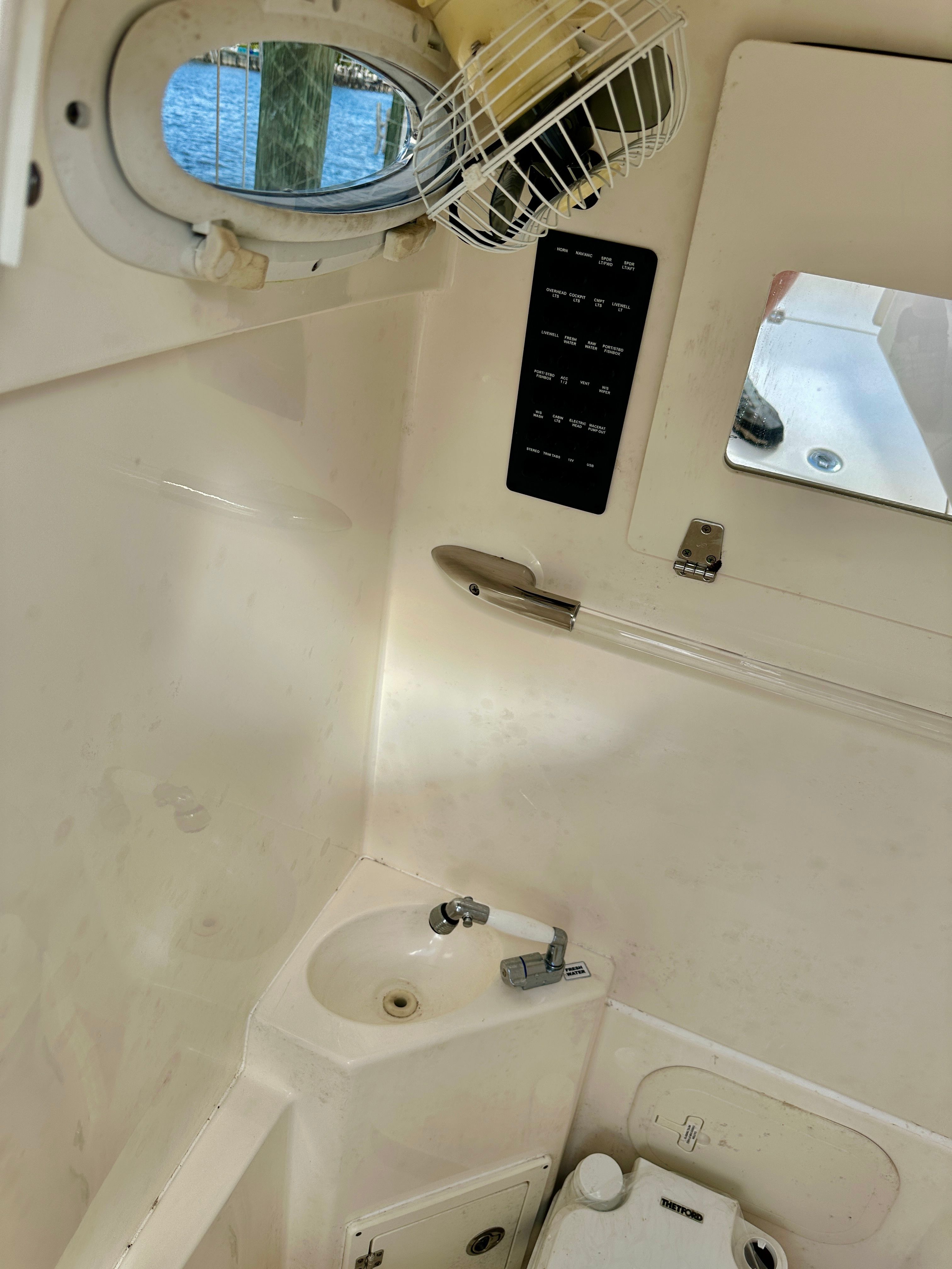 Interior of a 2022 Cobia 240 Center Console with a sink and mirror.