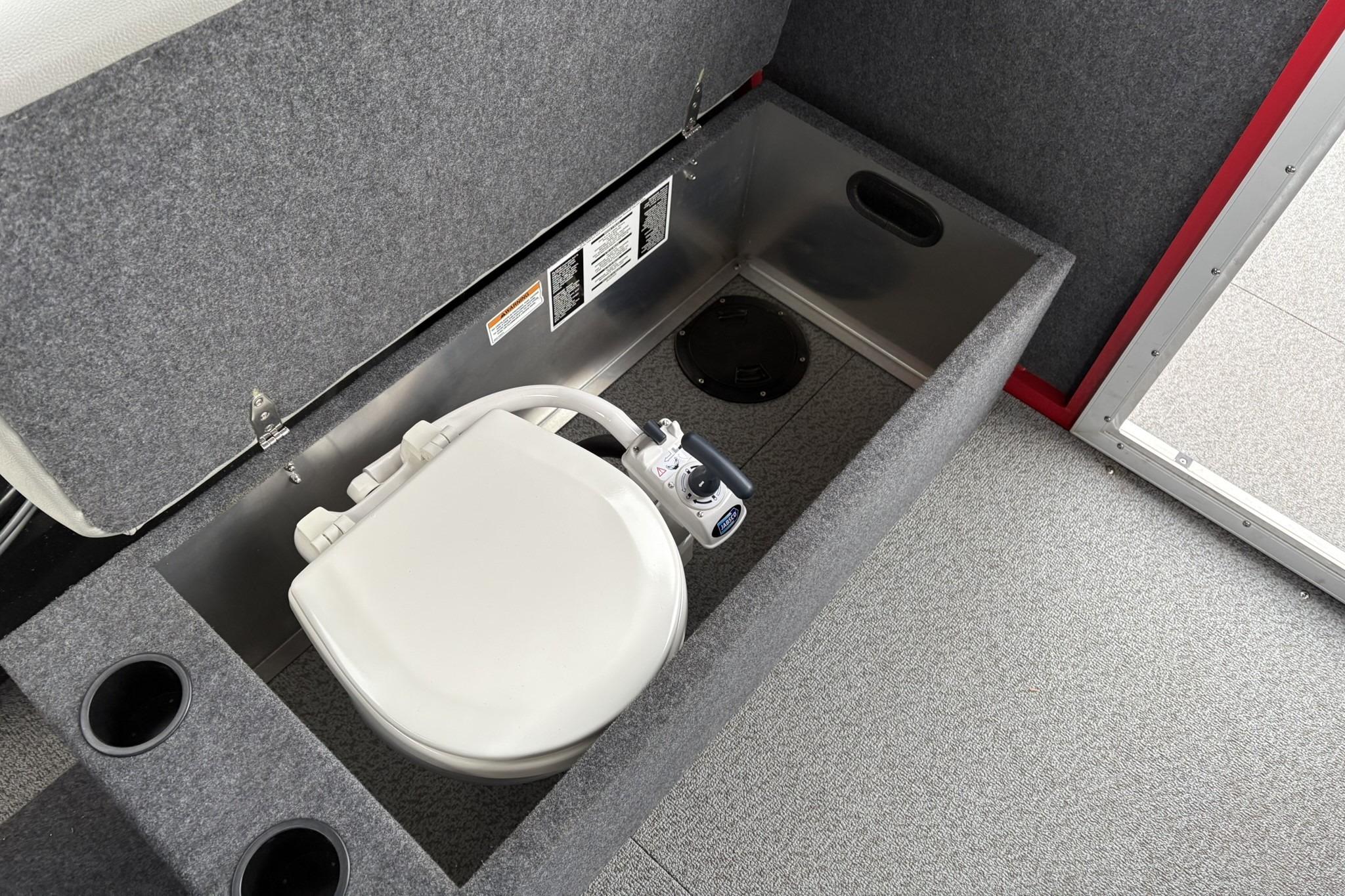 2024 Spartan 240 Maximus Pro interior with built-in toilet and storage compartment.