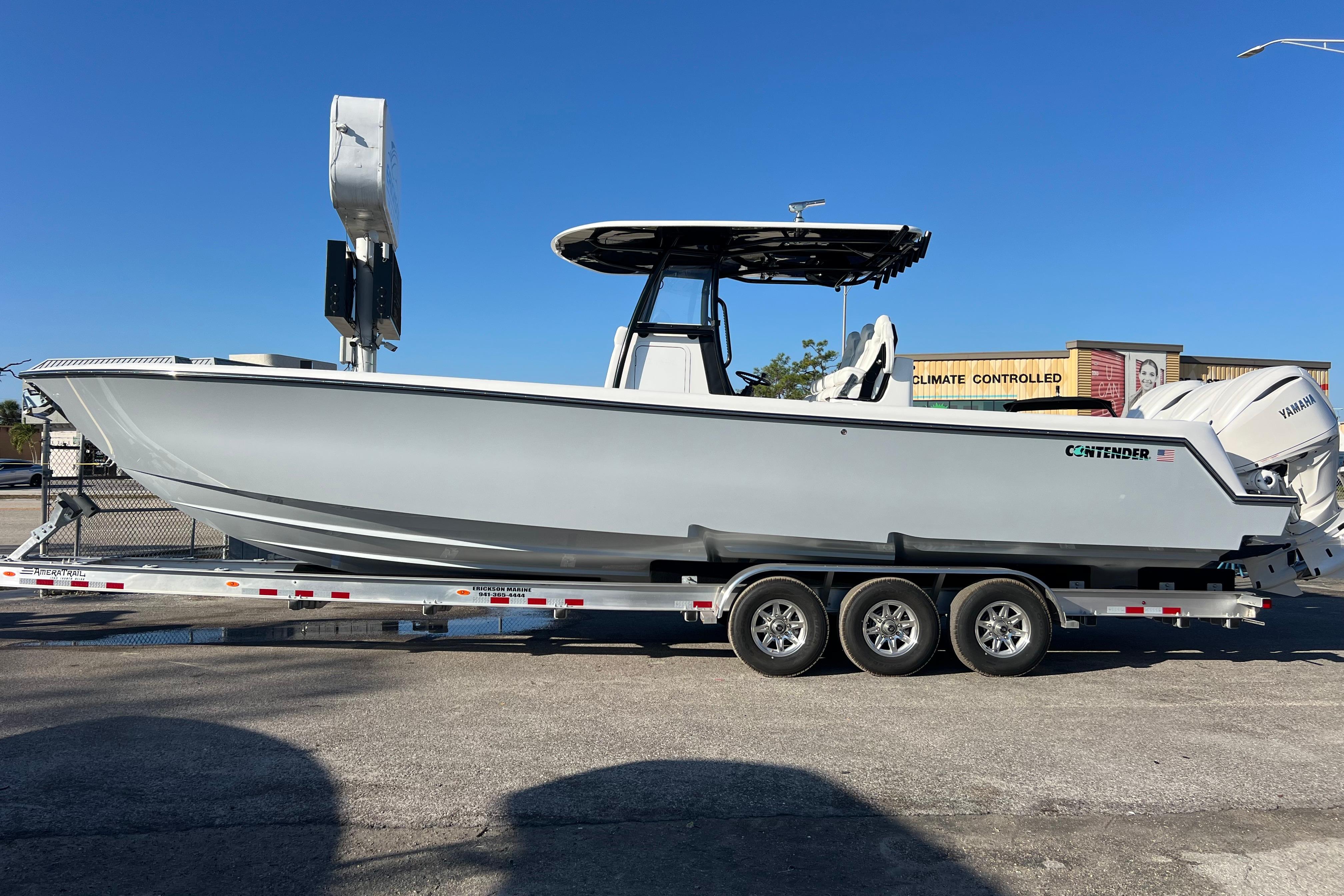 2026 Contender 35 ST boat on trailer, featuring sleek design and triple-axle support.