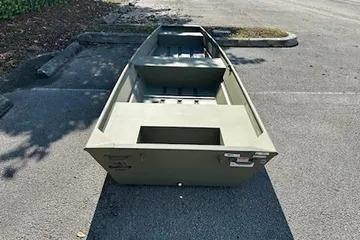2026 Tracker Grizzly 14 Jon boat parked on asphalt, rear view.