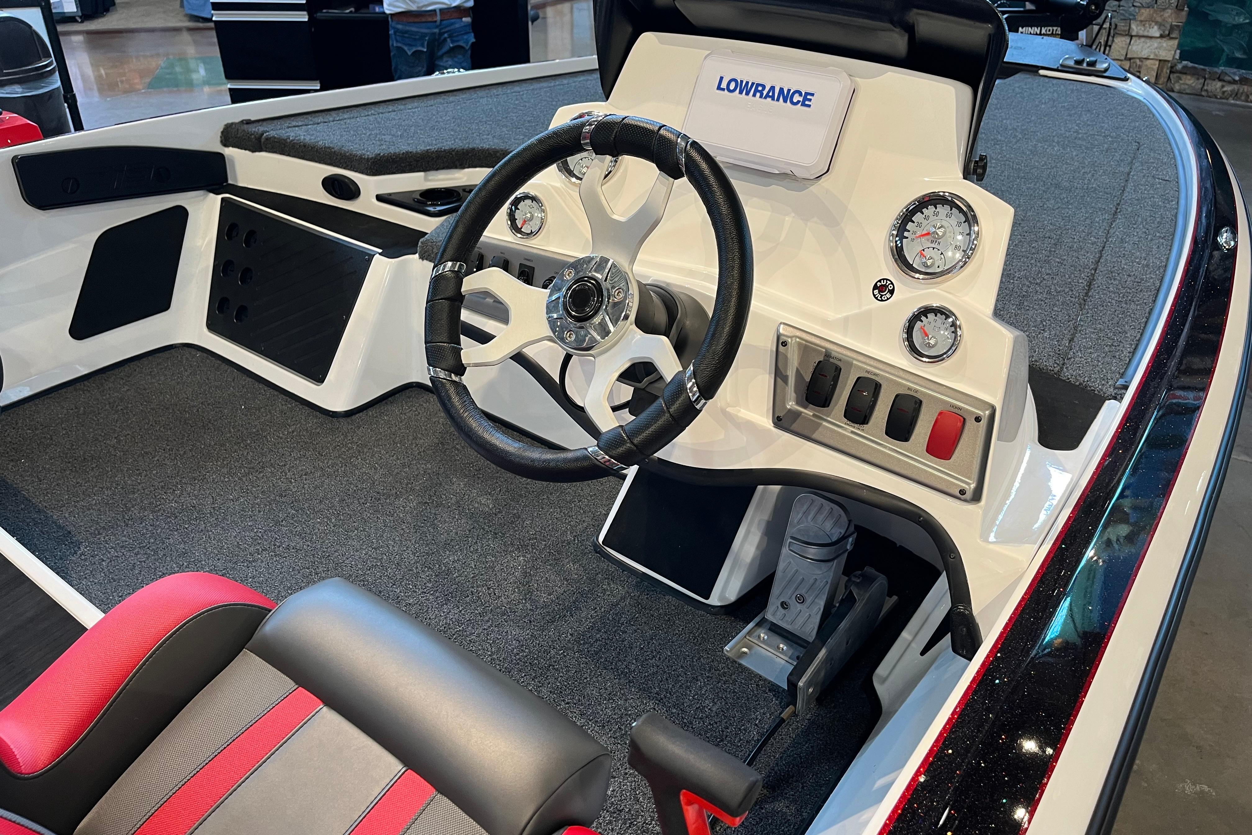 2025 Nitro Z19 boat cockpit with steering wheel, gauges, and Lowrance display.