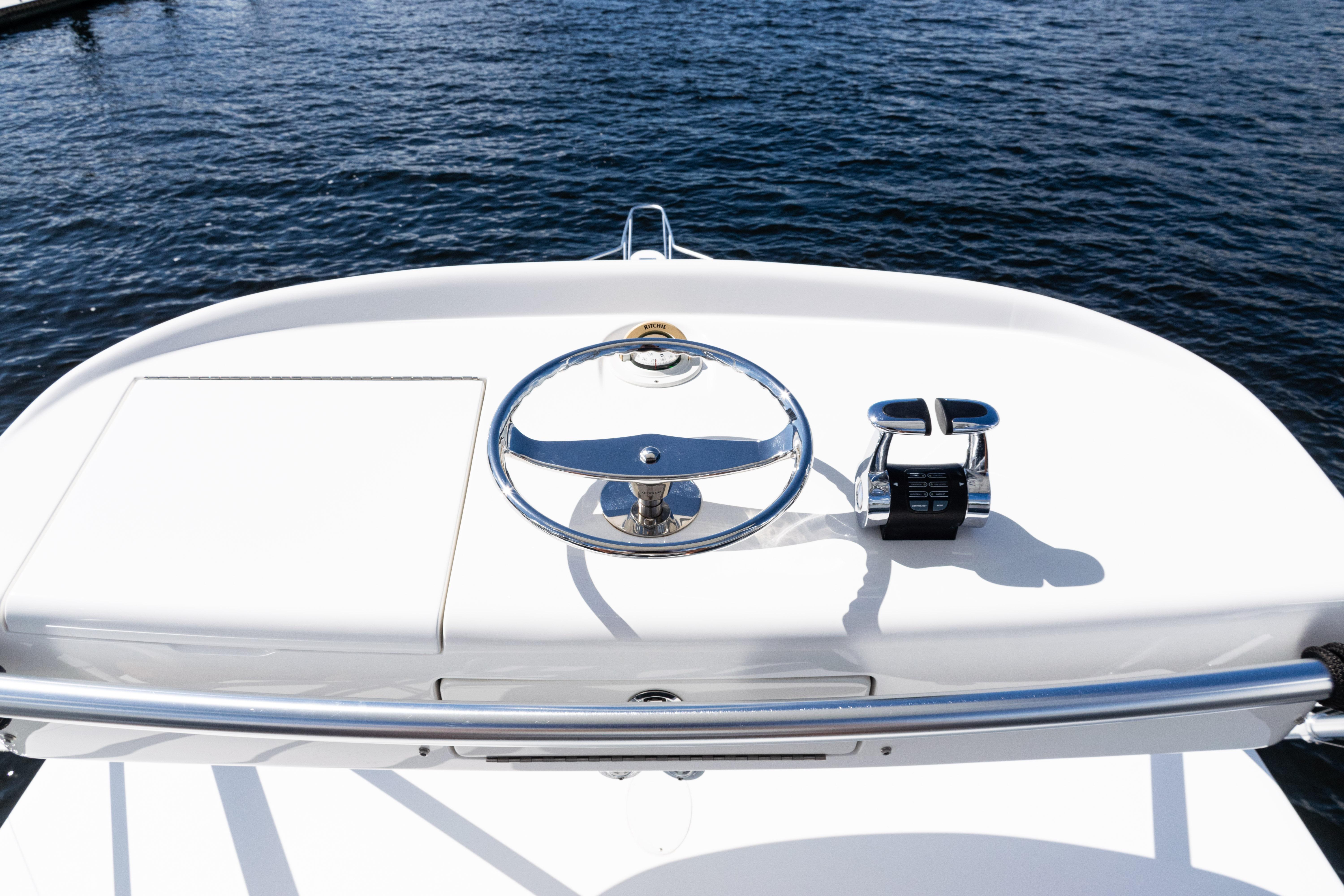 Steering console of 2021 Viking 44 Open yacht on calm water.