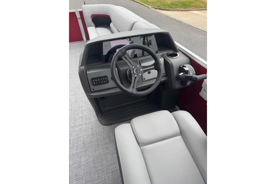 2026 Sun Tracker Party Barge 22 DLX interior with steering console and seating.