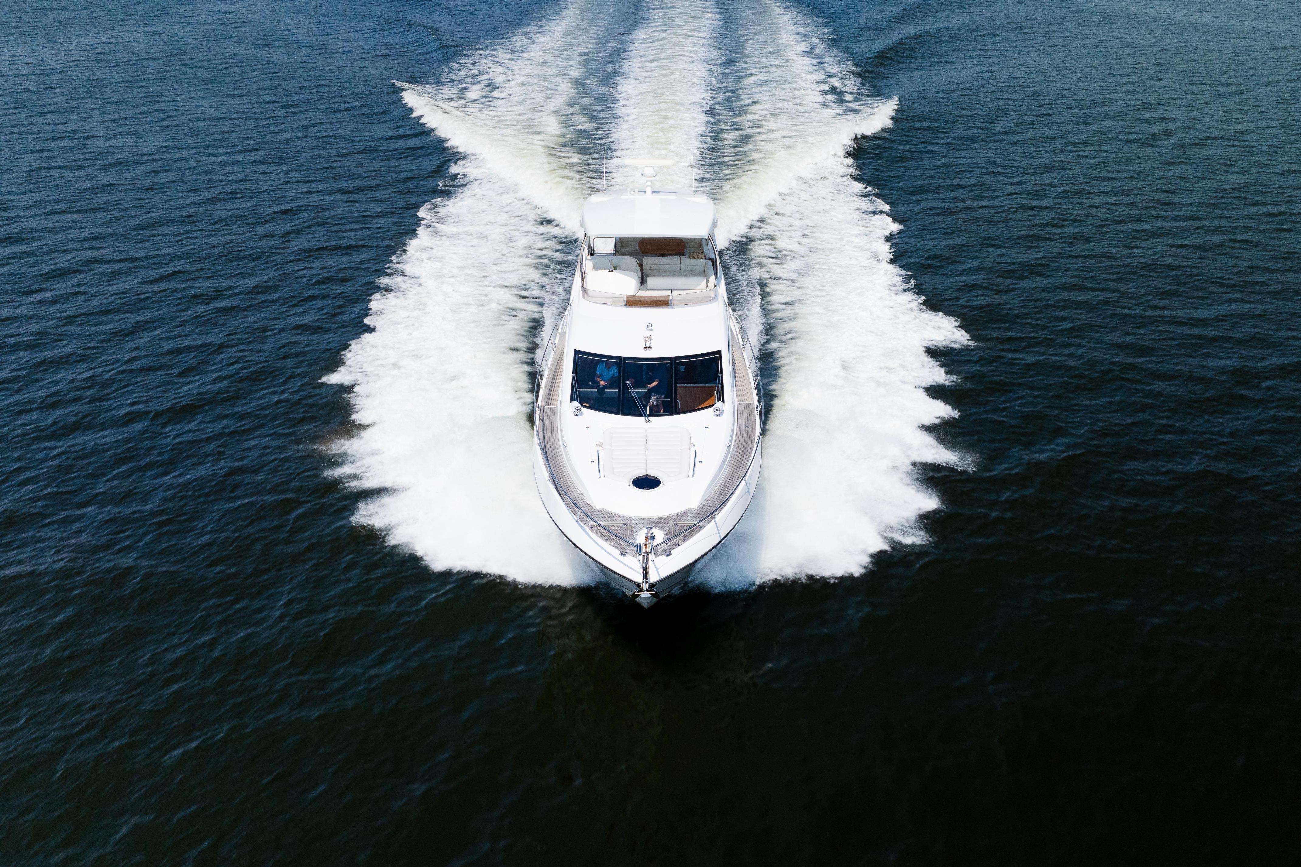 2016 Sunseeker Manhattan 65 yacht cruising on open water, aerial view.