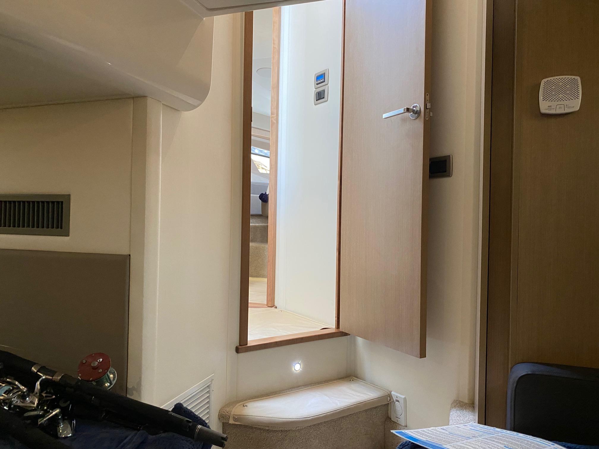 Interior of 2018 Sea Ray 400 Fly yacht, featuring a doorway and steps.