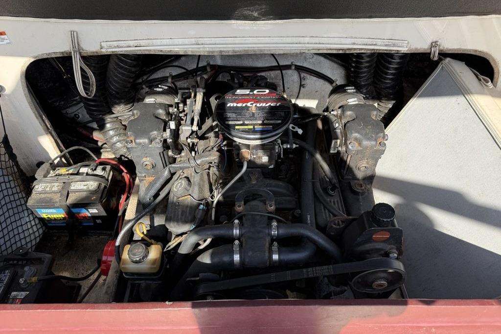 Engine compartment of a 1999 Glastron GT 225 boat with MerCruiser 5.0 engine.