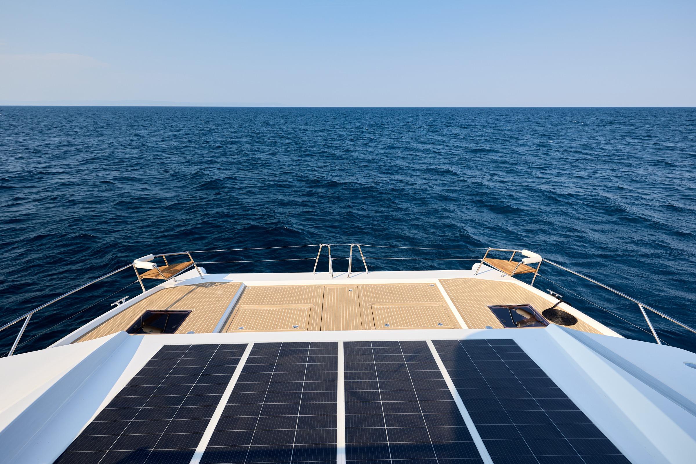 Custom Omaya 50 Power Catamaran 2025, featuring solar panels, cruising on open sea.