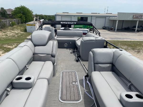 2023 Regency 250DL3 pontoon boat with spacious seating and modern design.