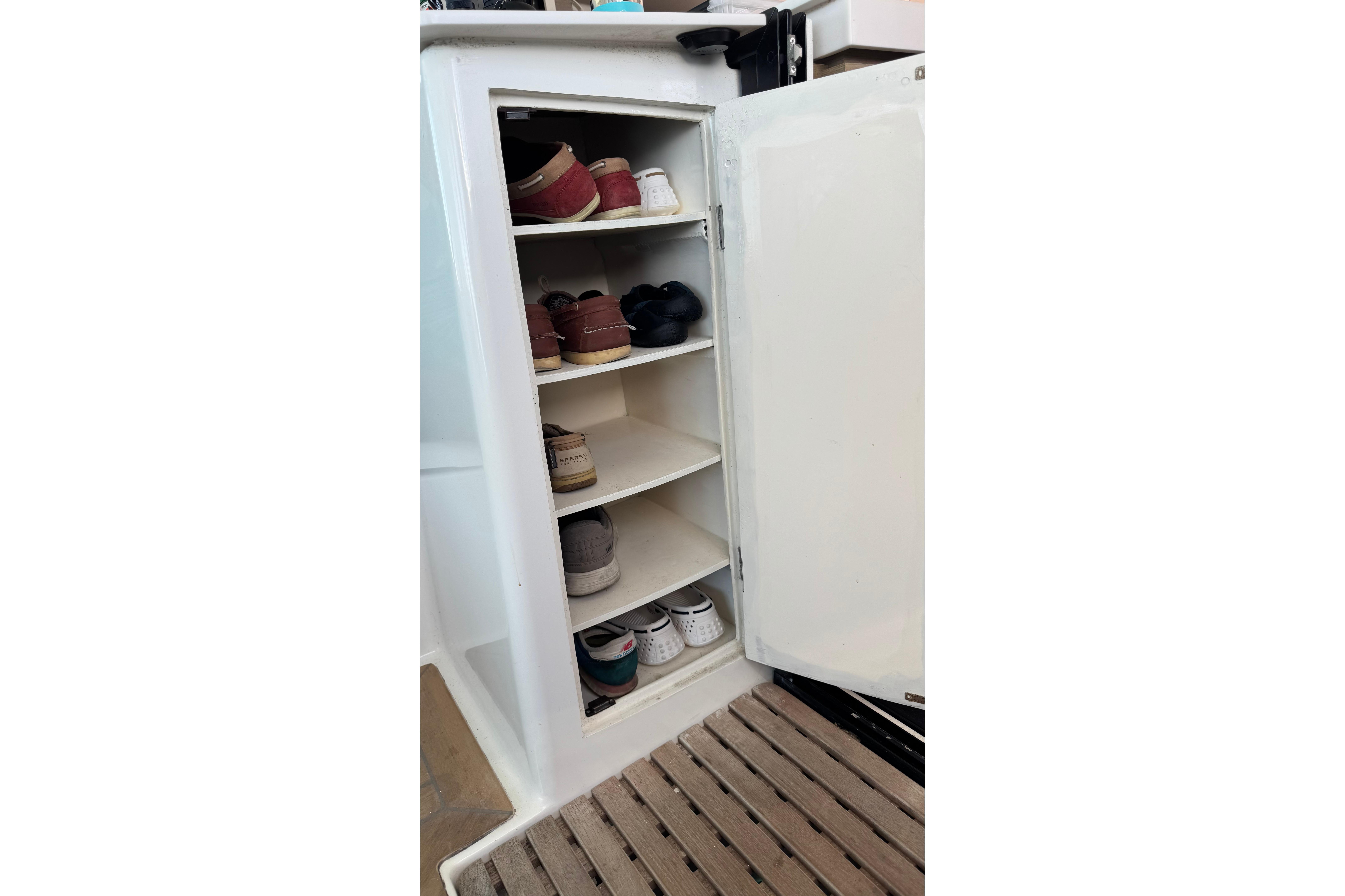 Shoe storage cabinet on 2020 Fountaine Pajot Saona 47 yacht, featuring multiple shelves.