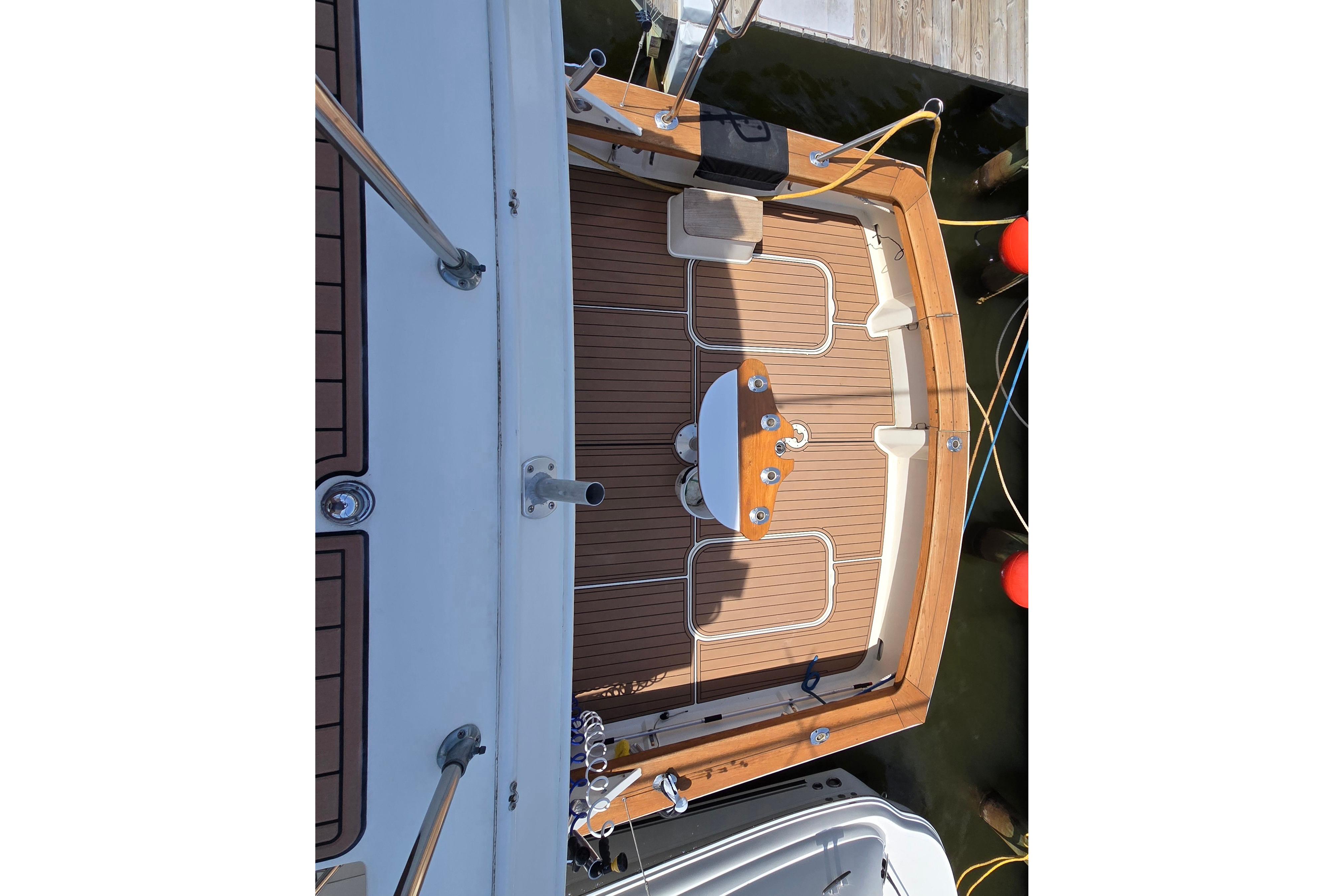 1988 Post 46 Convertible boat deck with wooden flooring and fishing equipment.