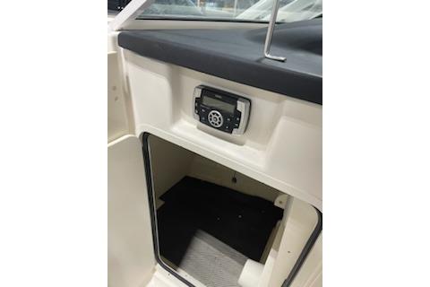 2022 Robalo R247 Dual Console interior with control panel and storage compartment.