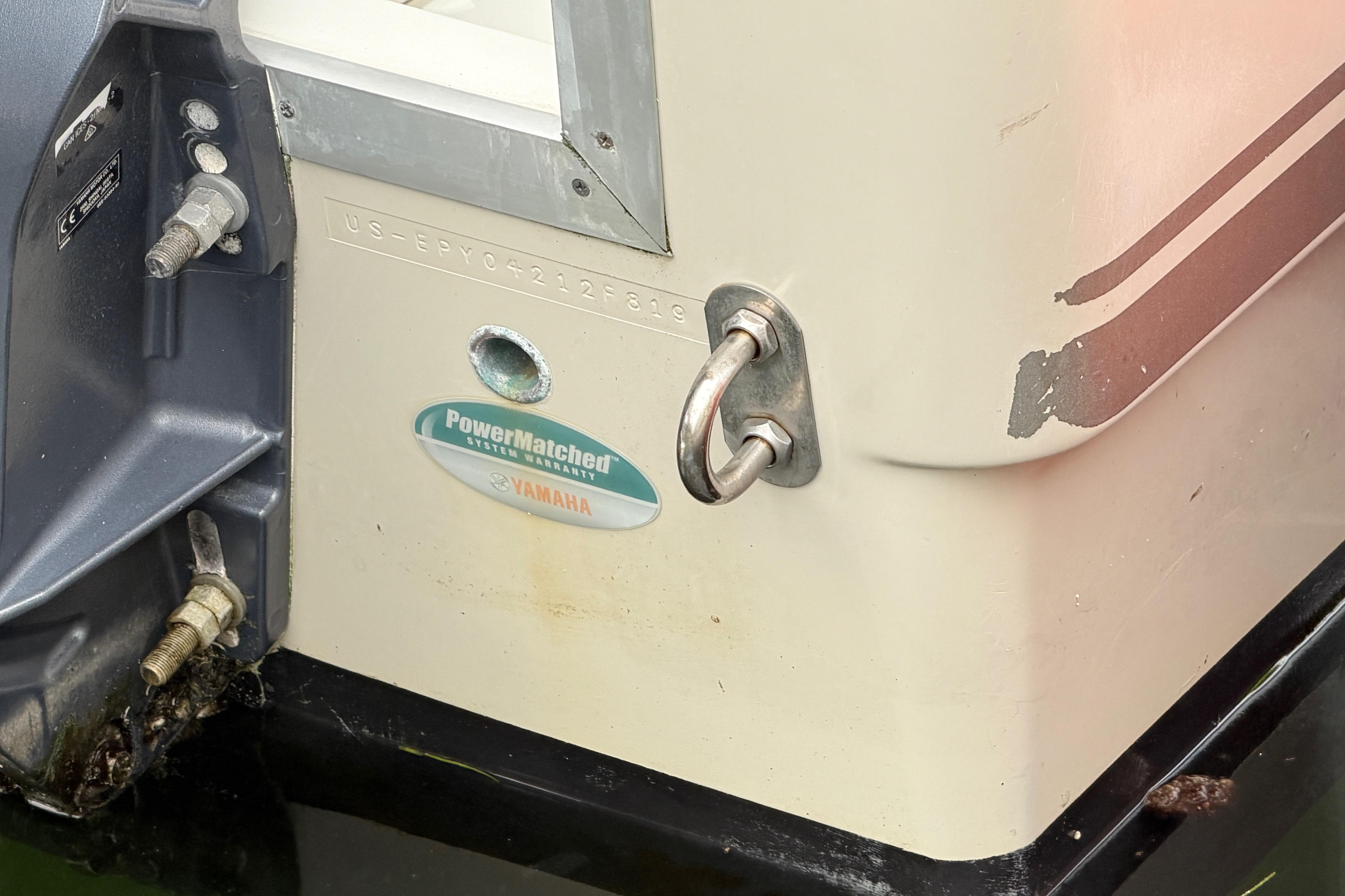 2019 World Cat 230 DC boat stern with Yamaha PowerMatched system warranty sticker.