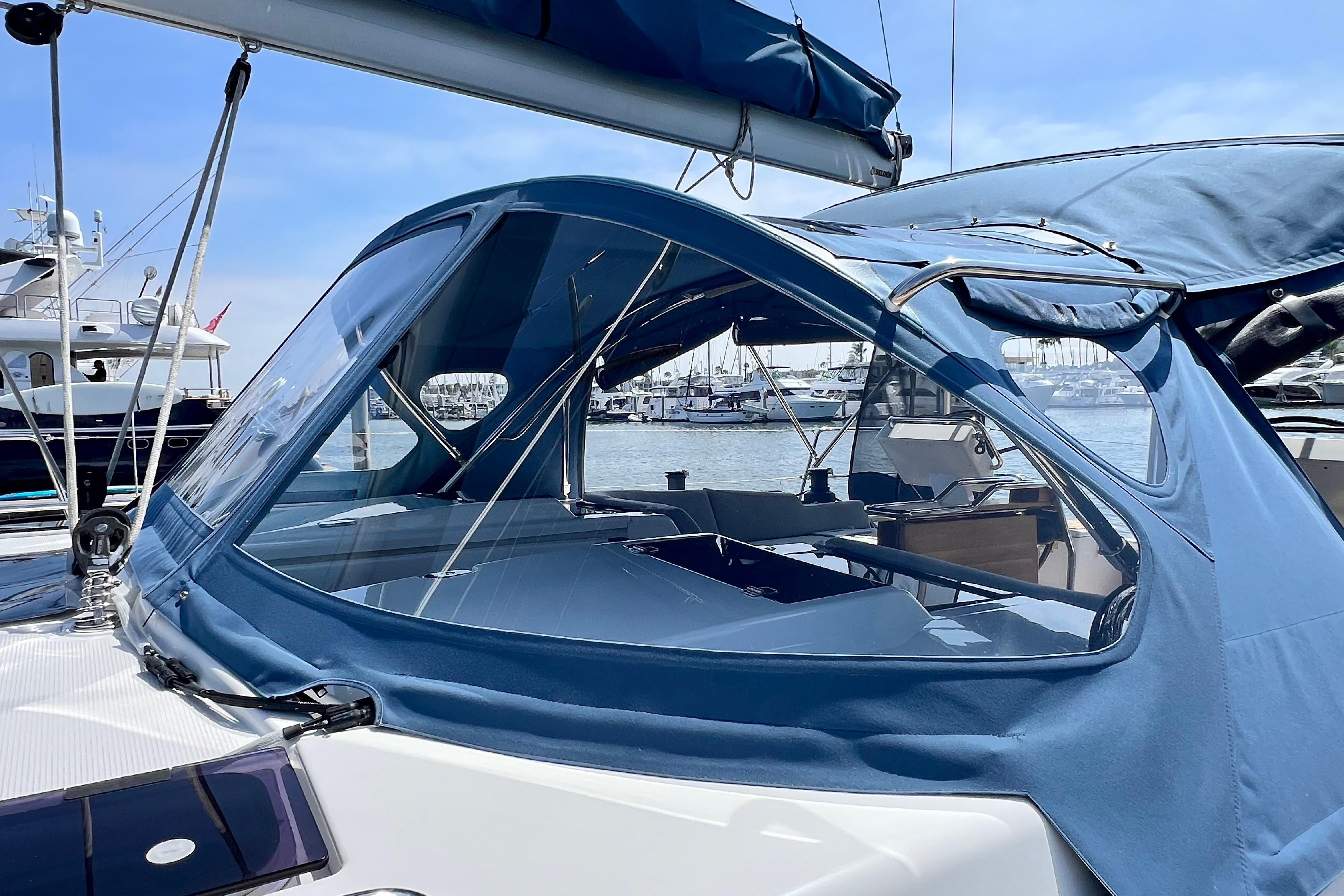 2016 Hanse 455 sailboat with blue canopy docked at marina.