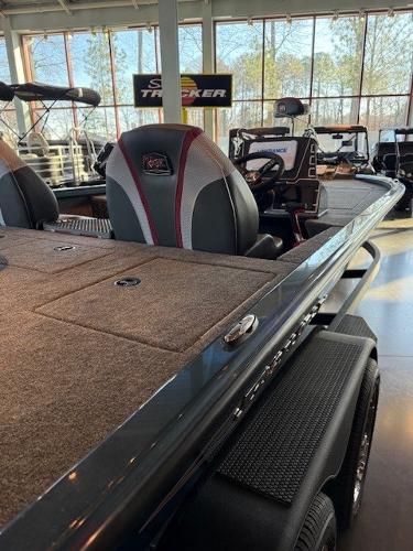 2025 Ranger ALPHA 208 boat interior with seating and dashboard in showroom.