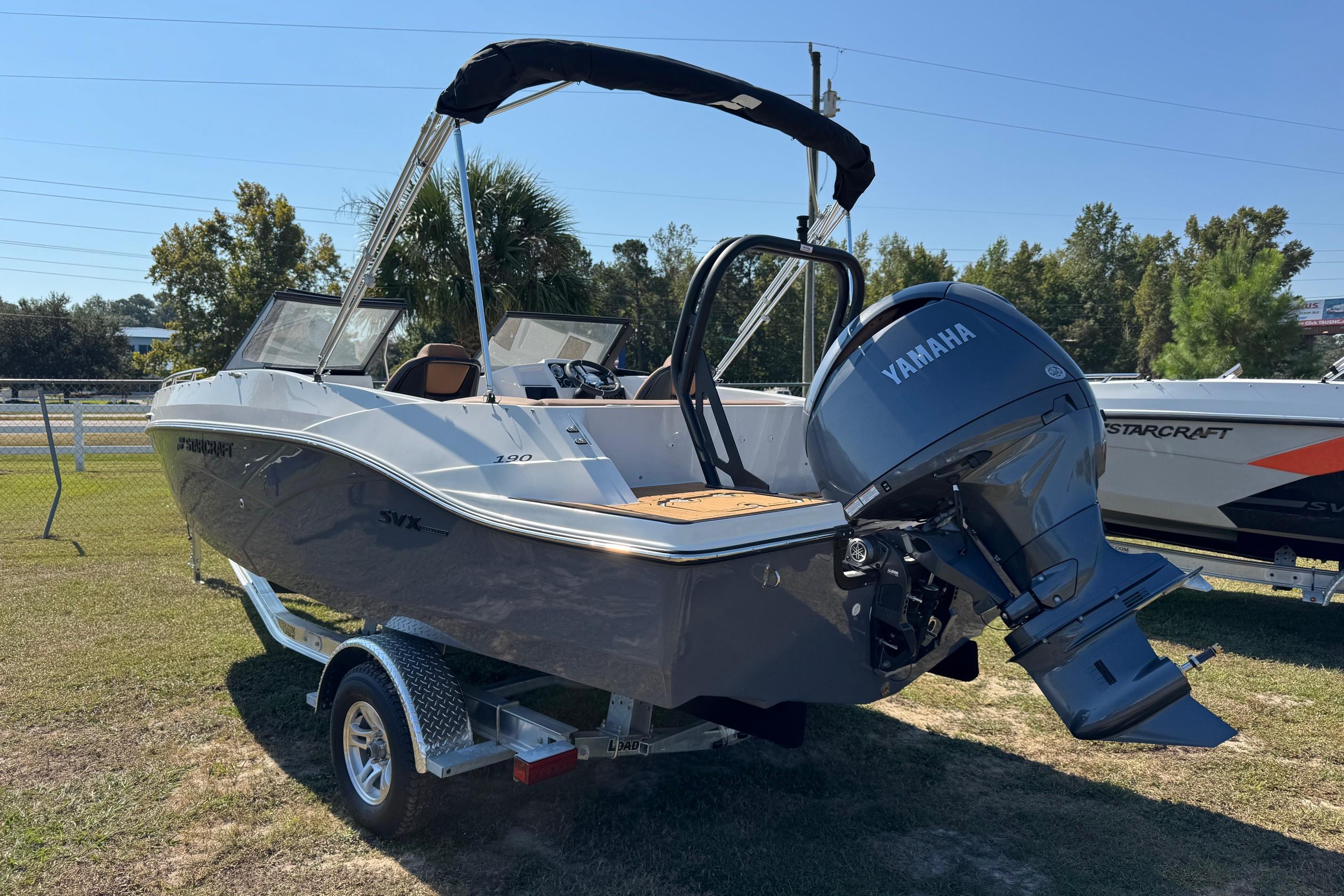 2026 Starcraft SVX 190 OB boat with Yamaha outboard motor on a trailer, parked on grass.