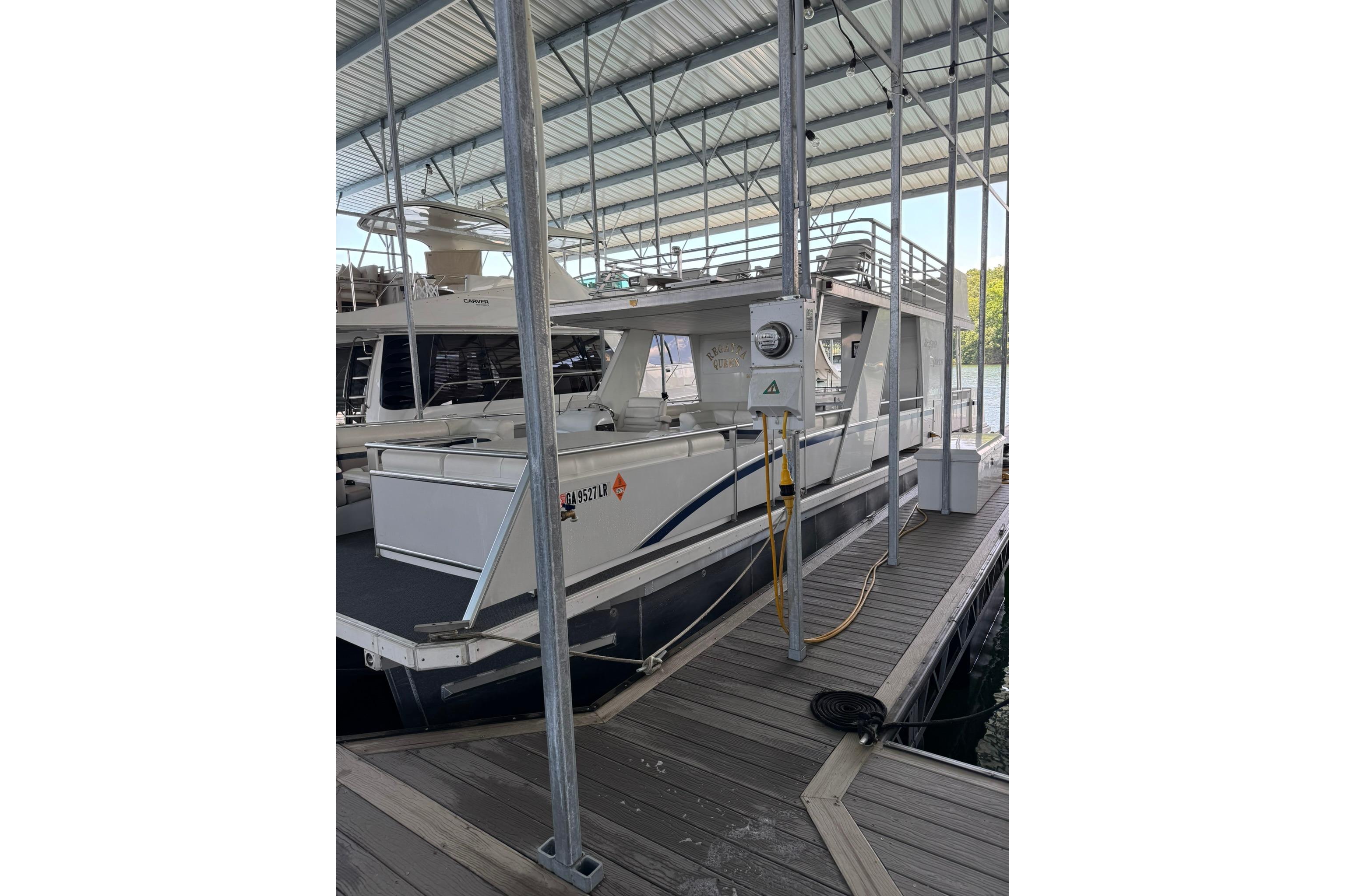 2008 Destination Yachts 45X14 houseboat docked in a covered marina.