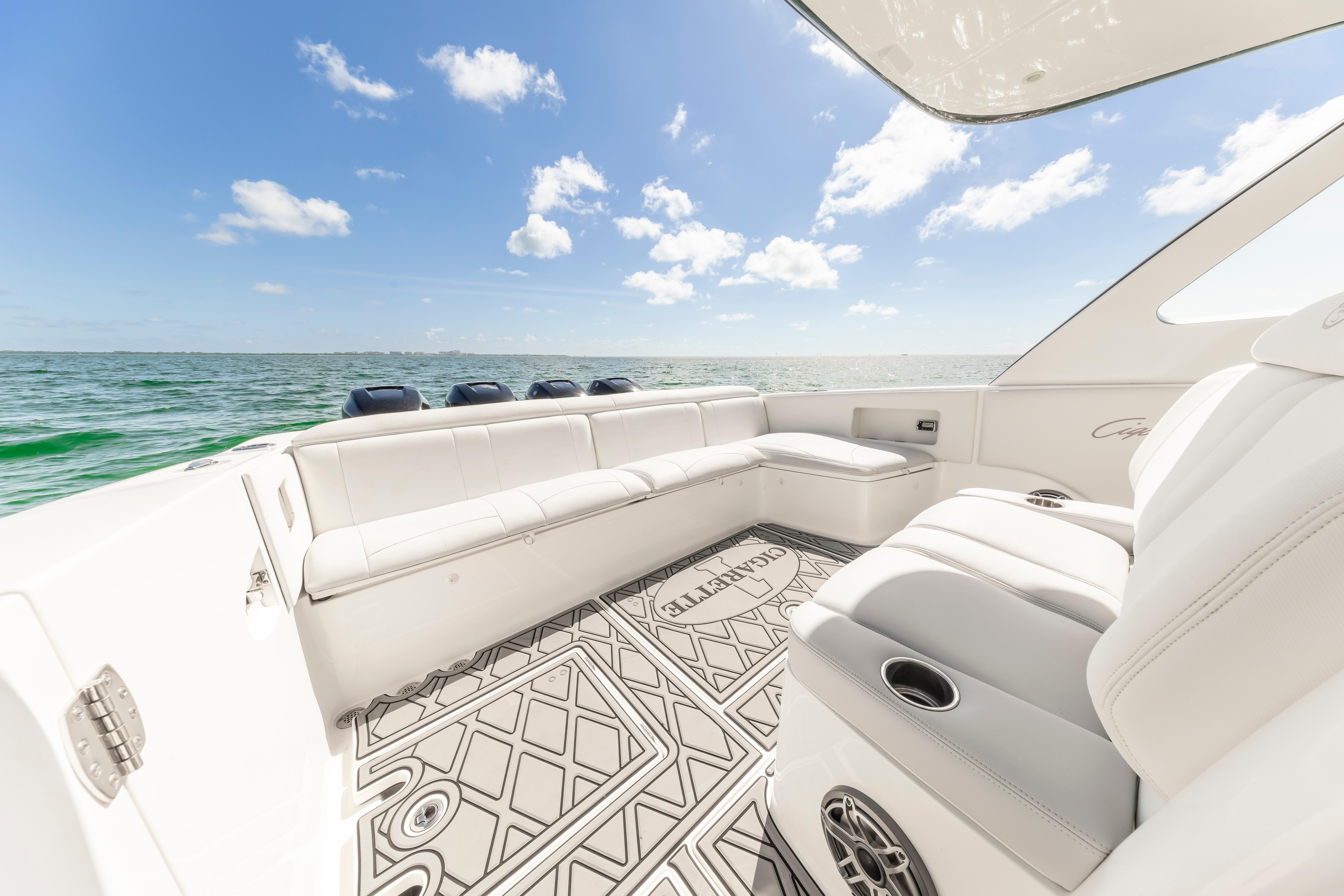 Luxurious 2016 Cigarette 41 GTR boat interior with ocean view and white seating.