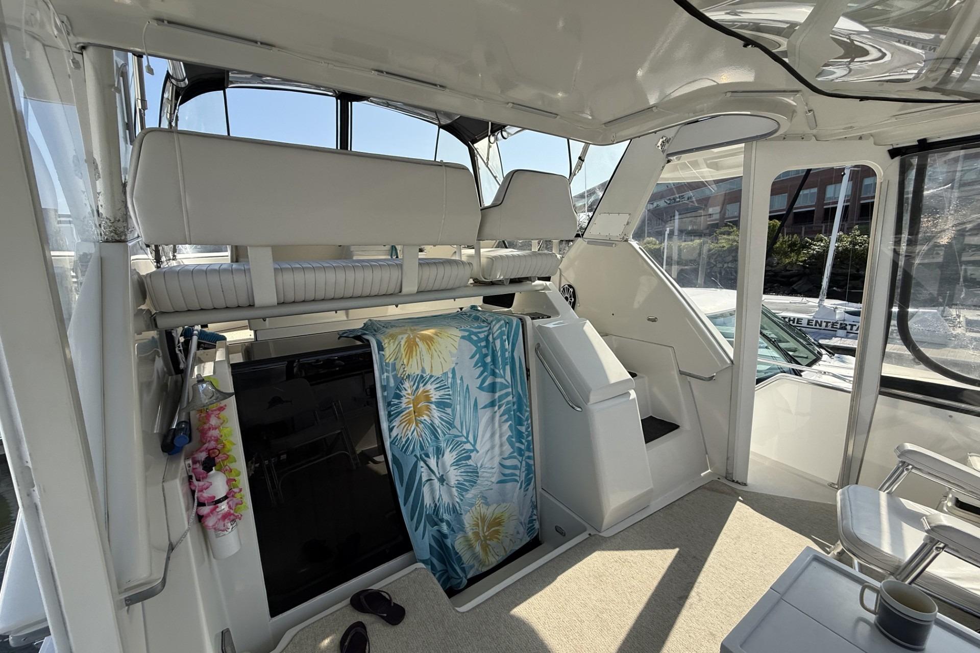 Interior of 1993 Carver 350 Motor Yacht with seating and tropical towel.