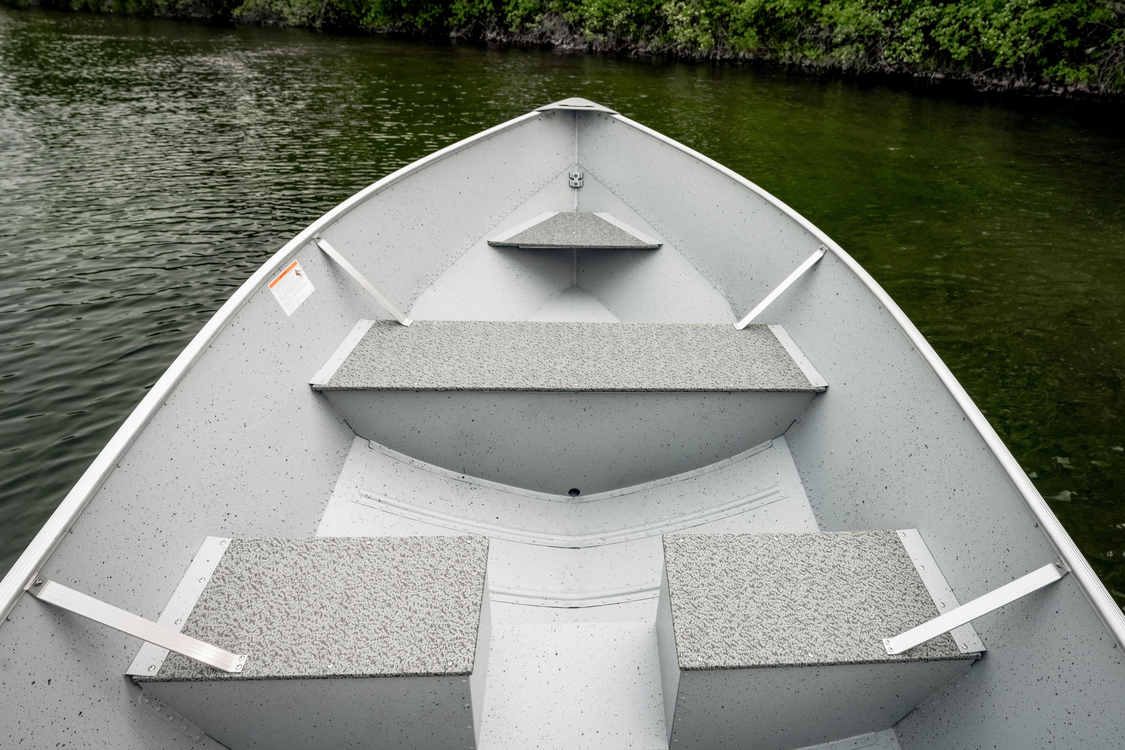 2027 Lund WC 16 boat interior on calm water, featuring durable seating and sleek design.