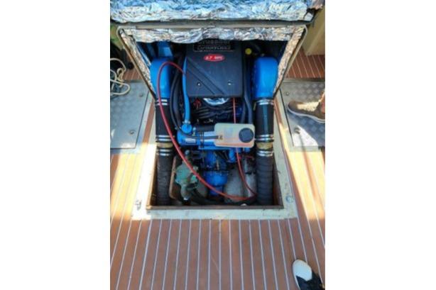 Engine compartment of a 1985 Wasque Down East Cruiser, showcasing detailed mechanical components.