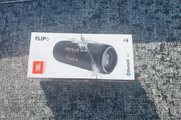 JBL Flip 6 Bluetooth speaker box on textured surface, 2026 Tracker Pro Team 195.