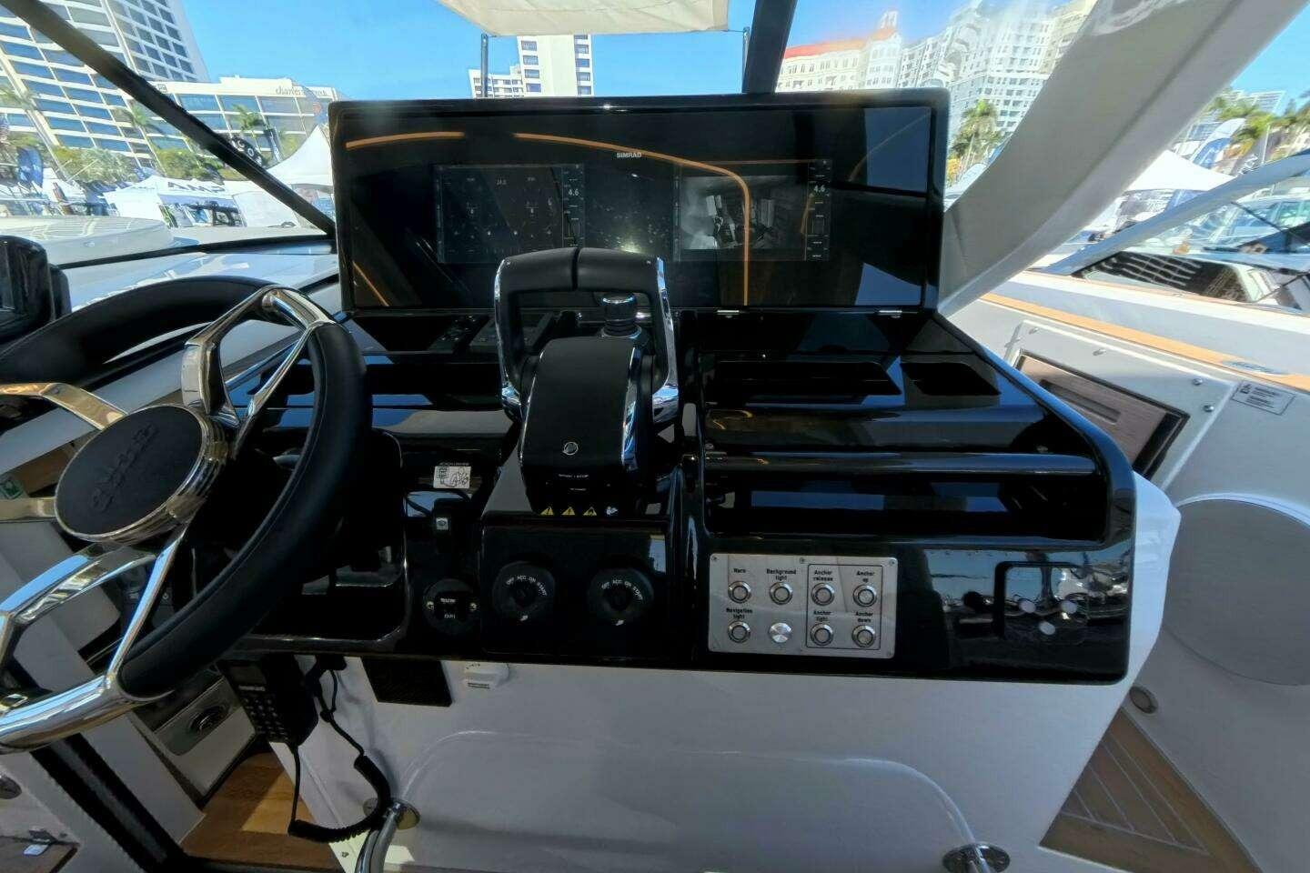 Helm of 2024 Fjord 41XP yacht with modern controls and navigation display.