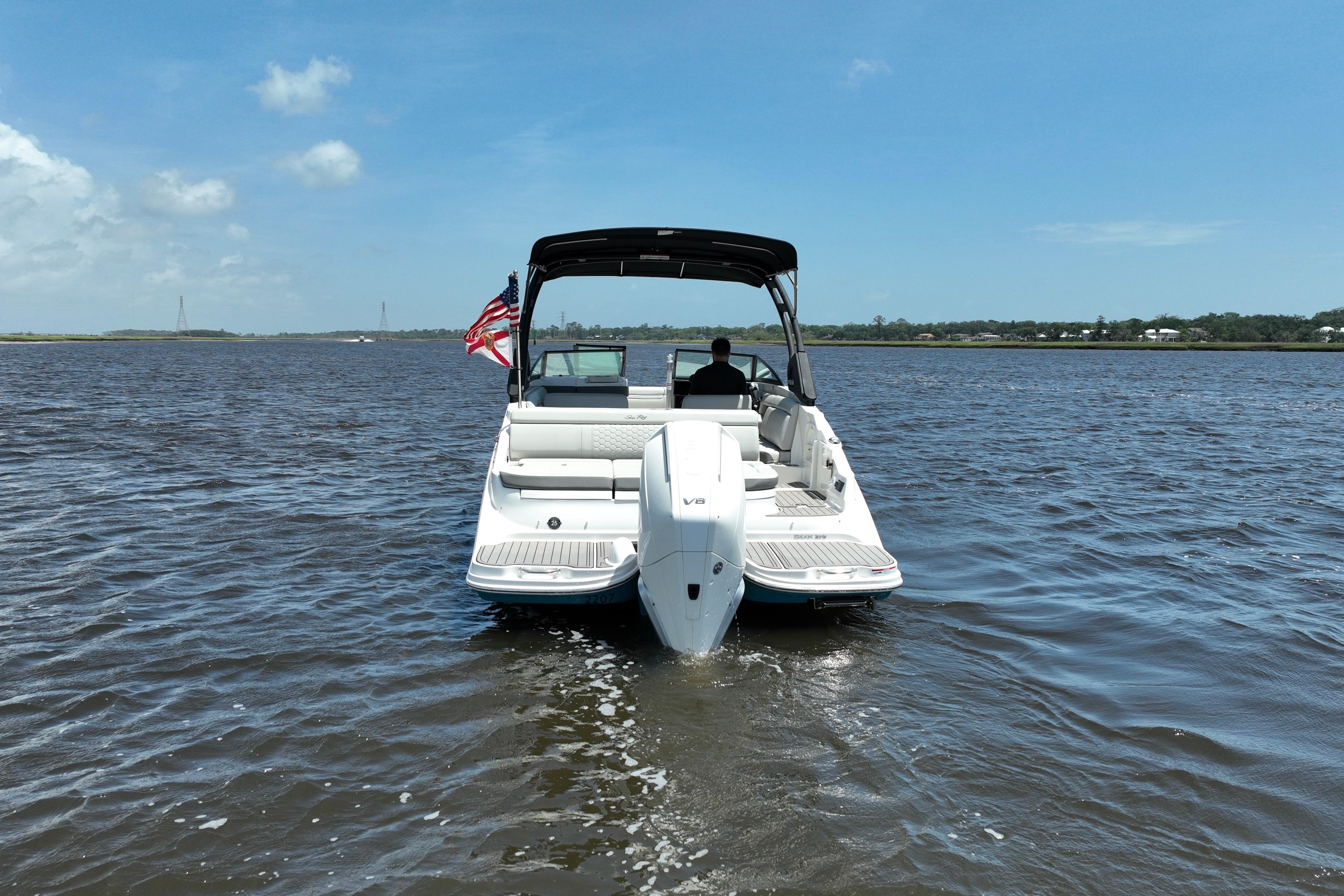 2024 Sea Ray SDX 270 Outboard boat cruising on a sunny day.