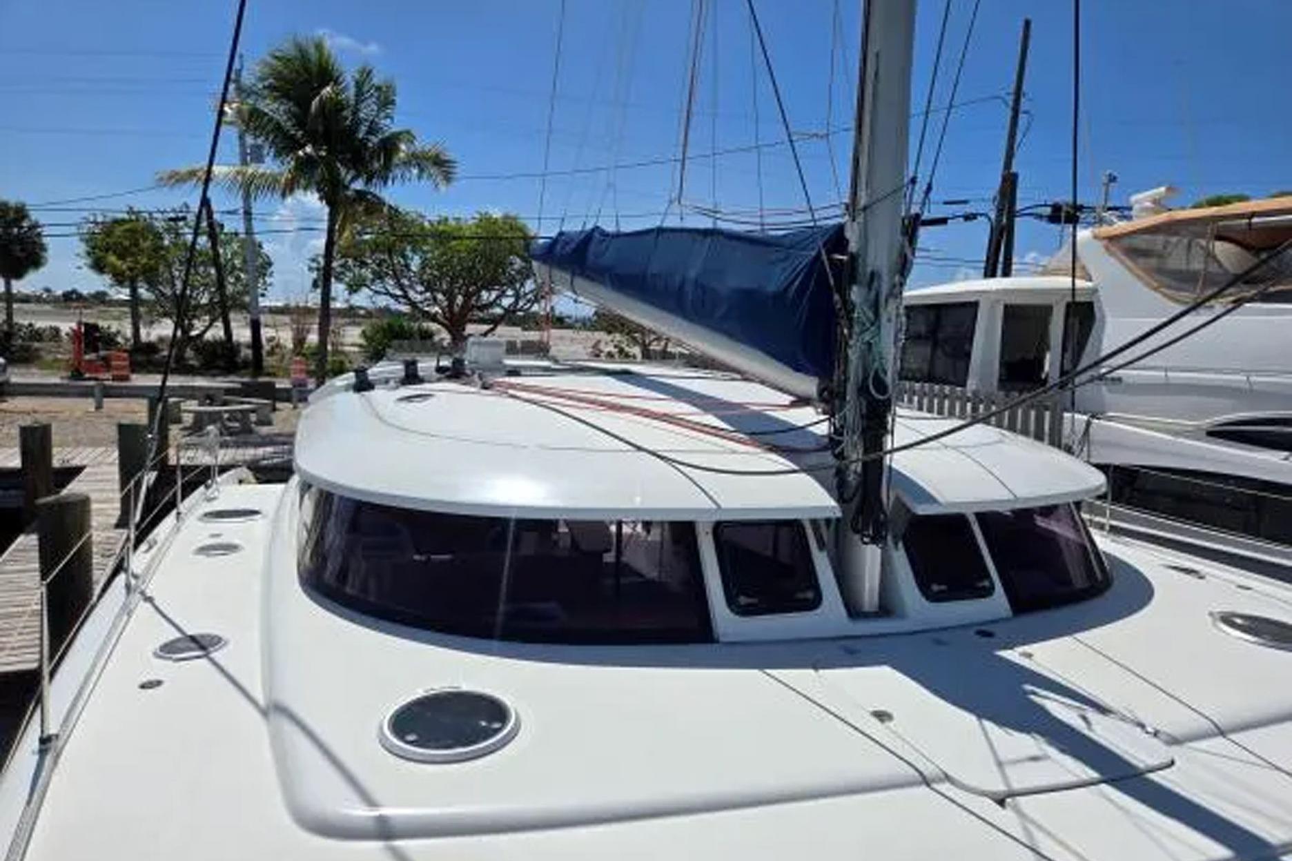 2008 Fountaine Pajot Salina 48 catamaran docked, featuring sleek design and spacious deck.