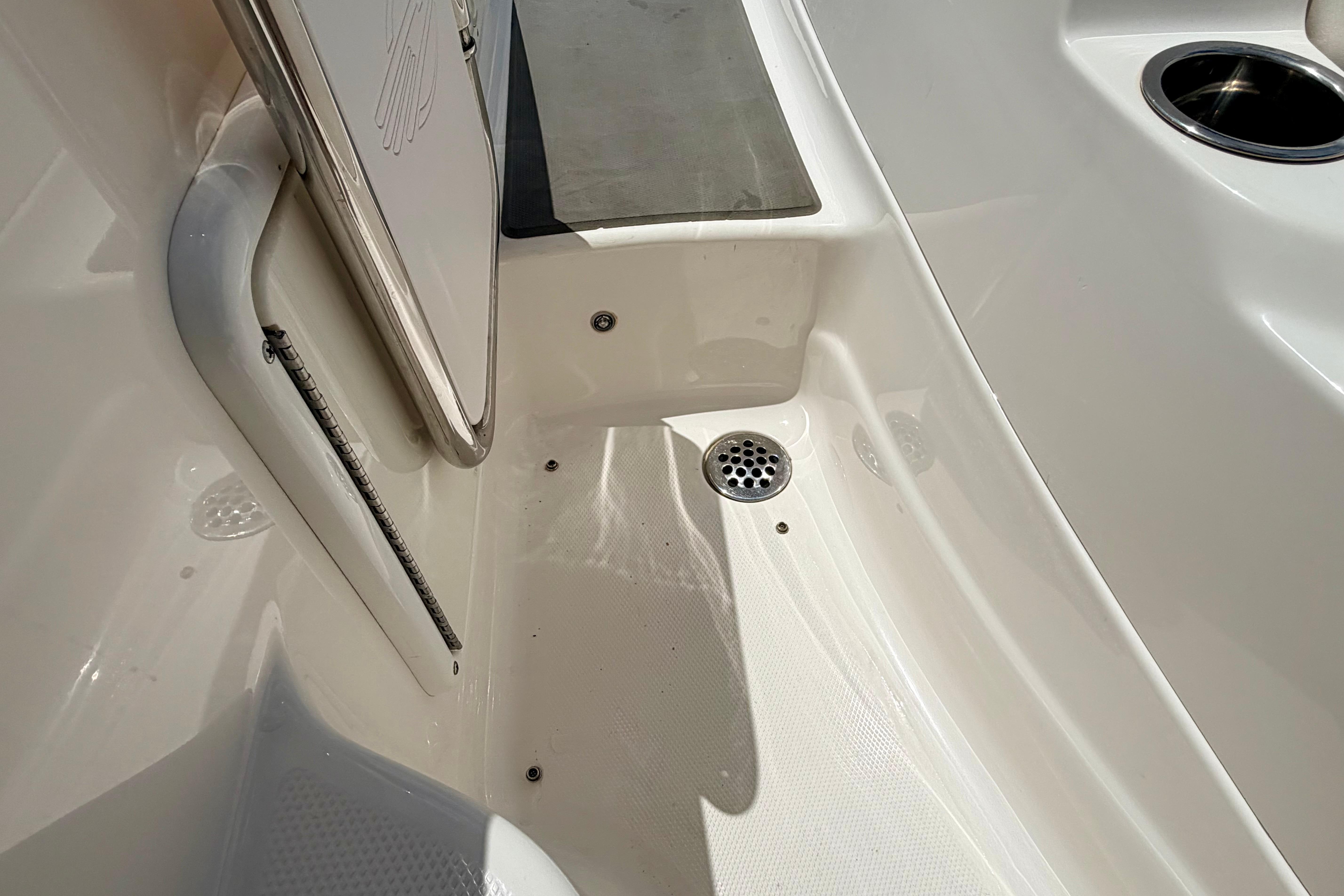 2015 Chaparral Sunesta 264 boat interior with drain and cup holder.