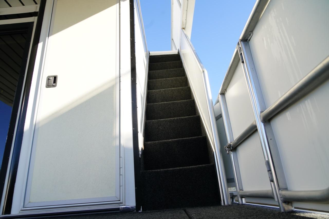 Staircase on 2000 Stardust Cruisers 83'x17' houseboat, leading to upper deck.