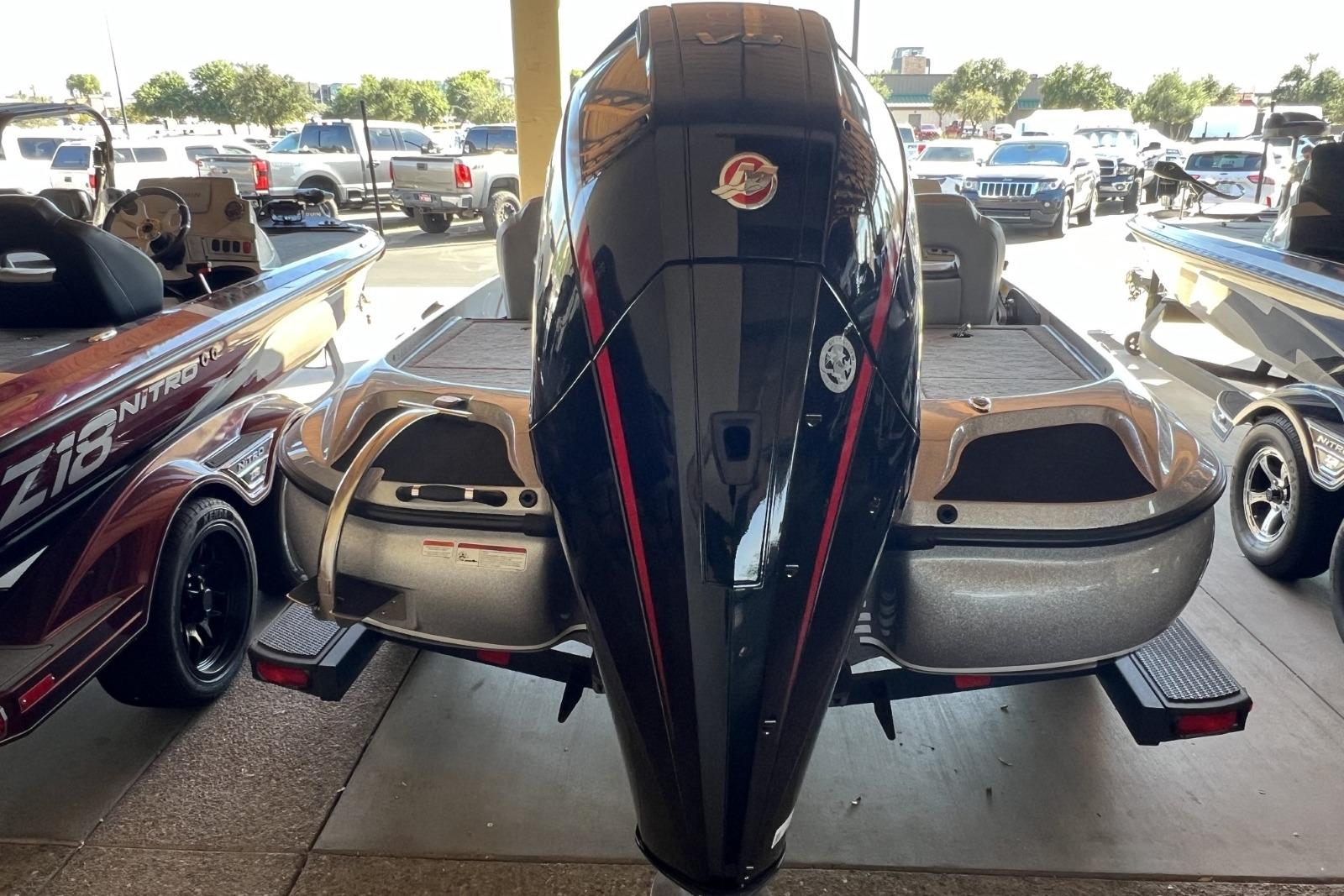 2025 Nitro Z19 boat with powerful outboard motor, parked in a dealership lot.
