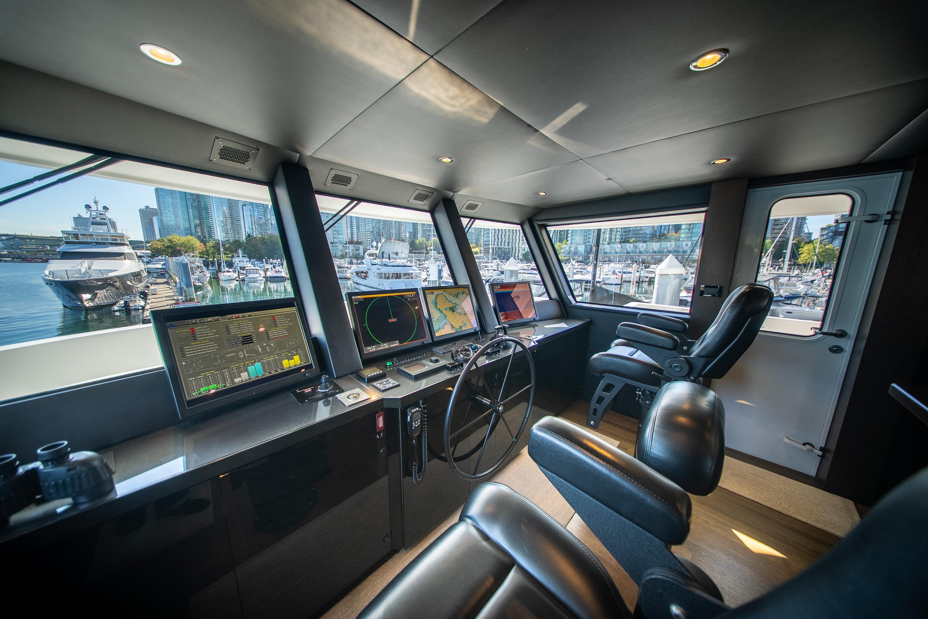 Luxurious 1992 Crescent Custom yacht cockpit with modern navigation systems and marina view.
