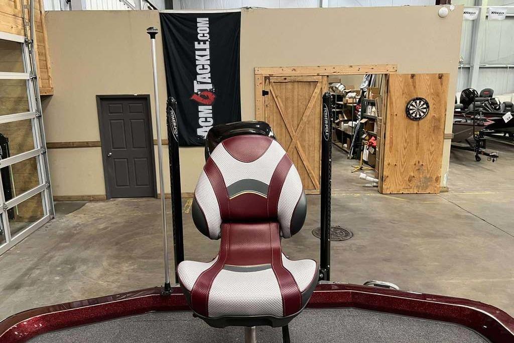 2018 Ranger Z520L boat seat in a garage with a dartboard and banner.