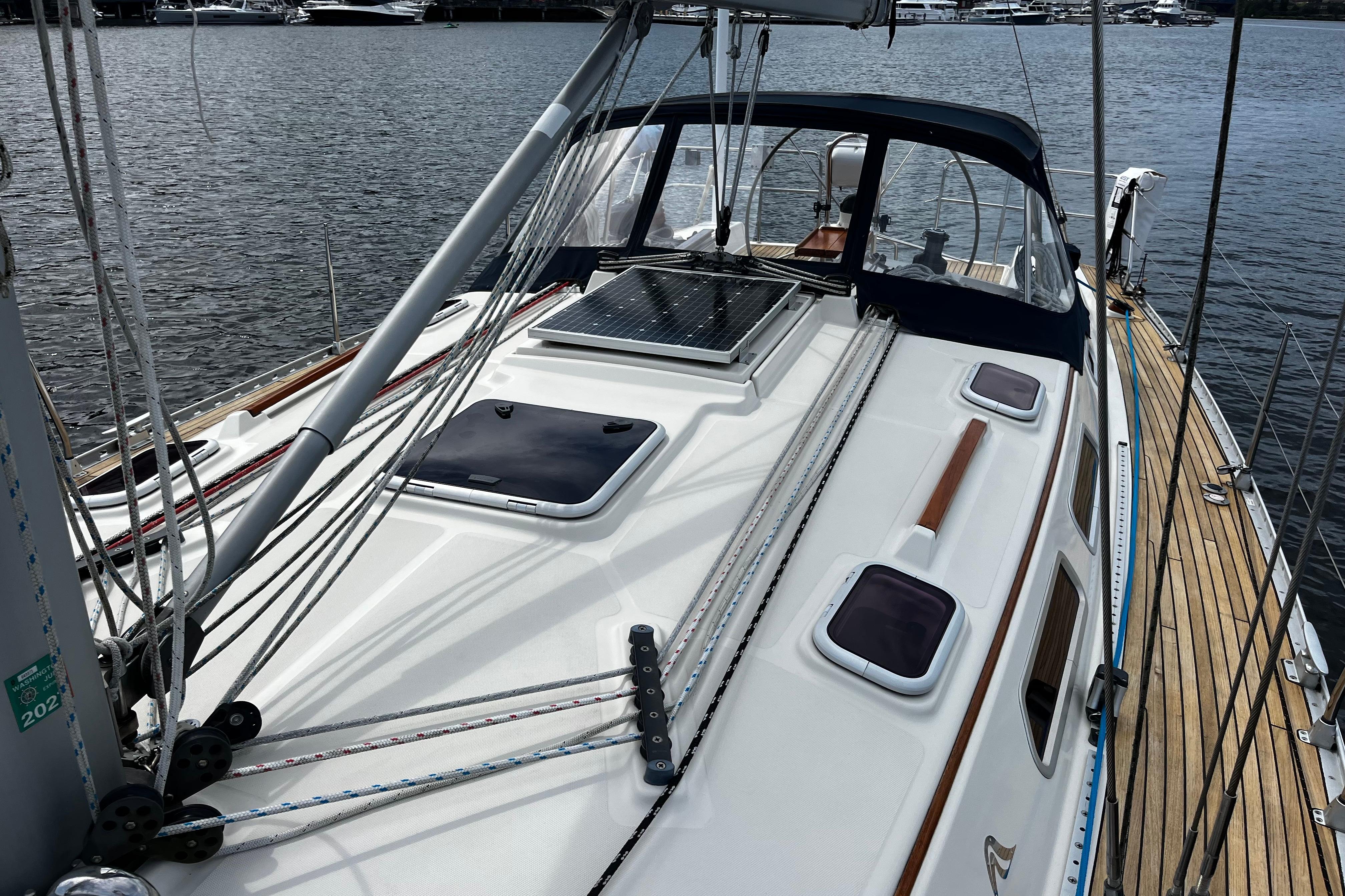 2004 Hanse 411 sailboat deck with rigging, docked by the water.
