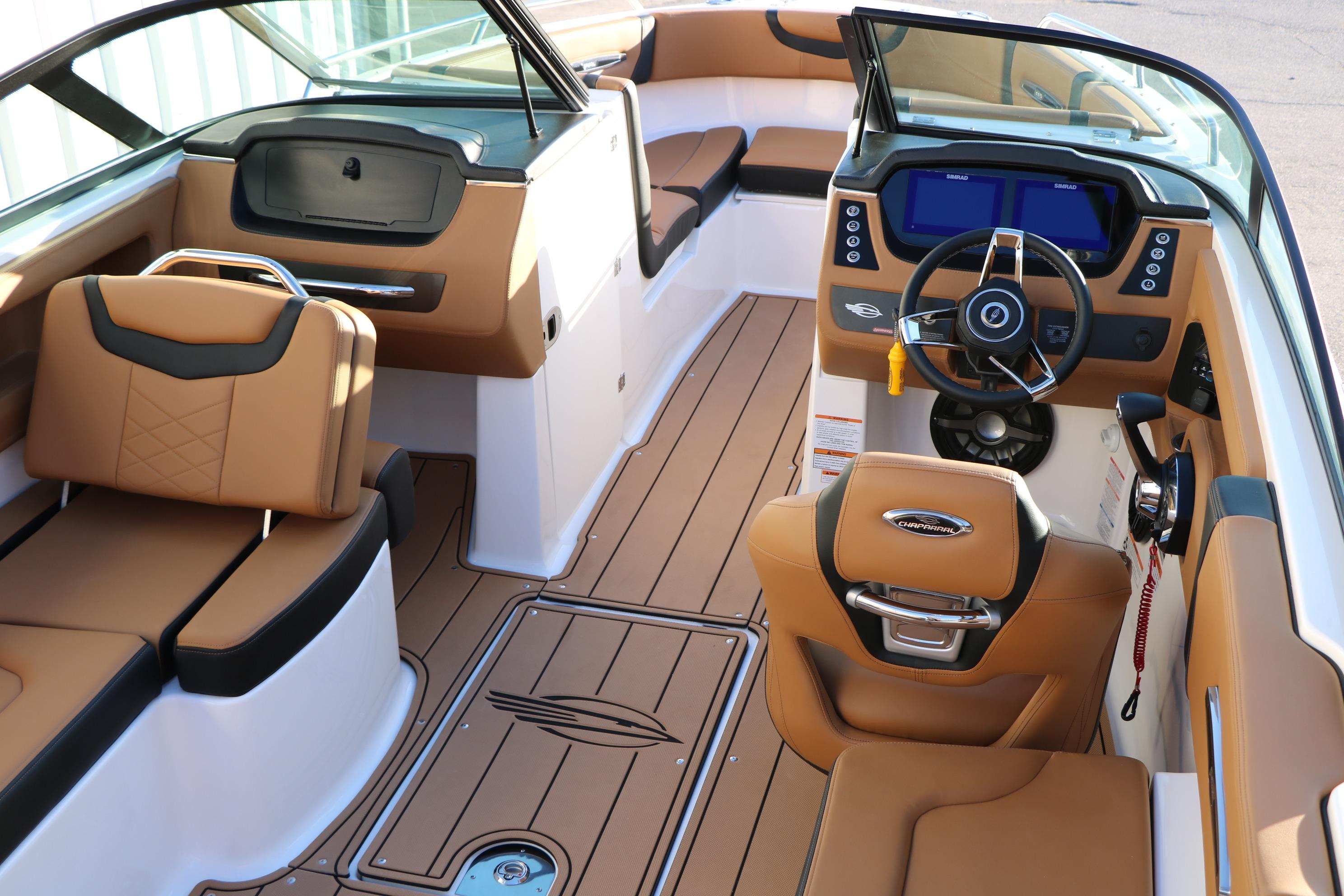 2026 Chaparral 247 SSX boat interior with tan seating and modern dashboard.