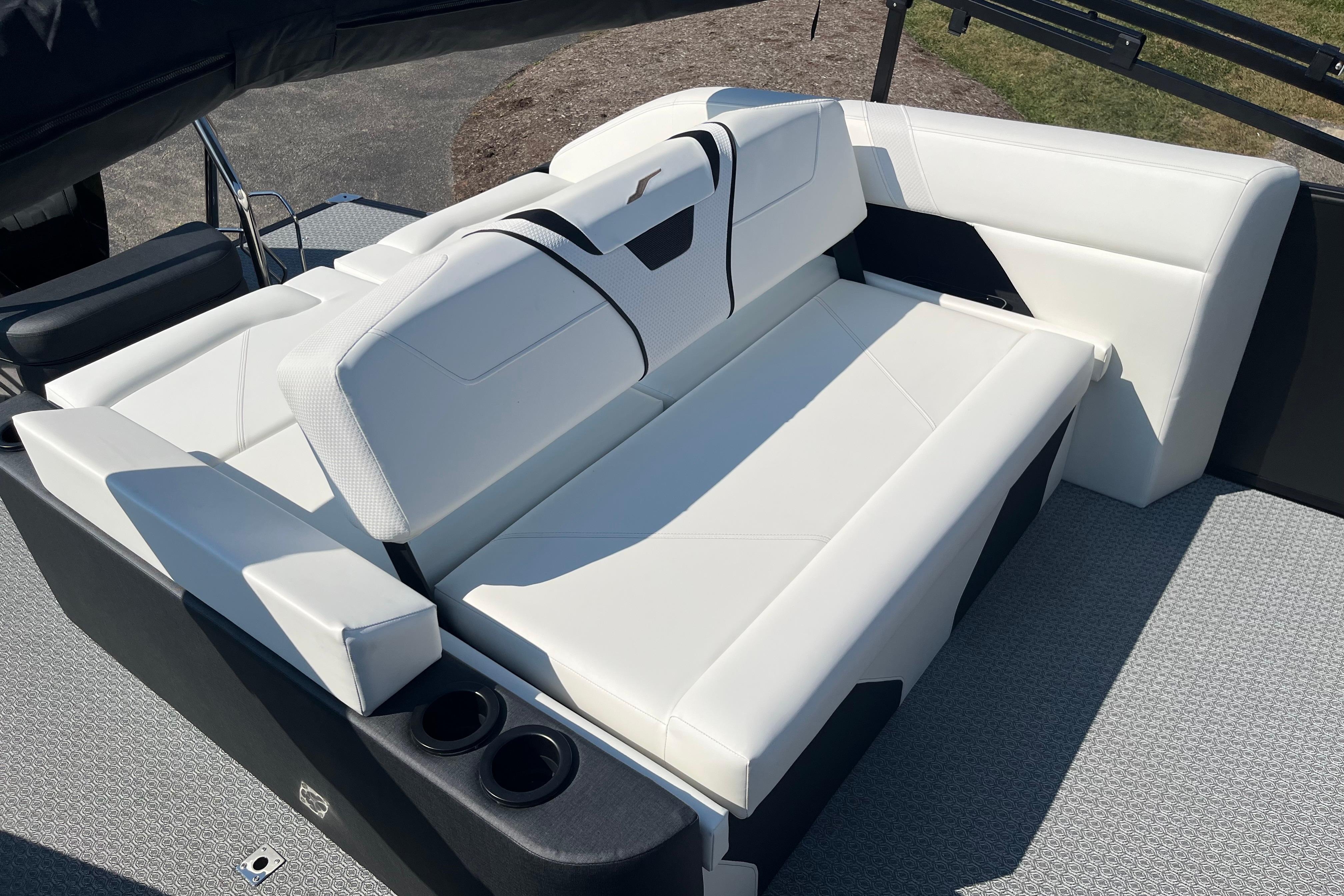 Luxurious white seating on 2026 Evotti 725CS boat, featuring cup holders and modern design.