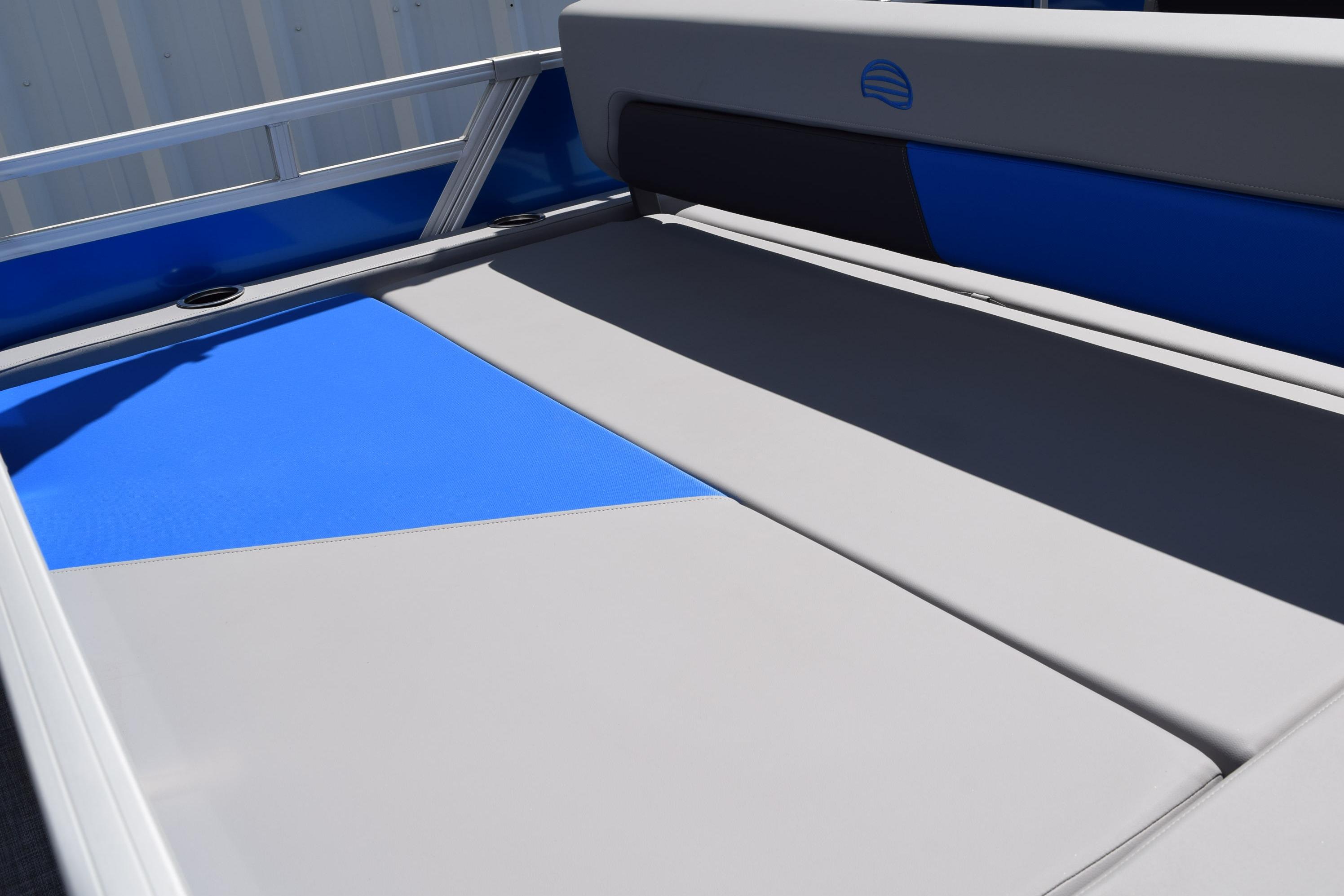 2026 Sun Tracker Party Barge 22 RF DLX interior with blue and gray seating.