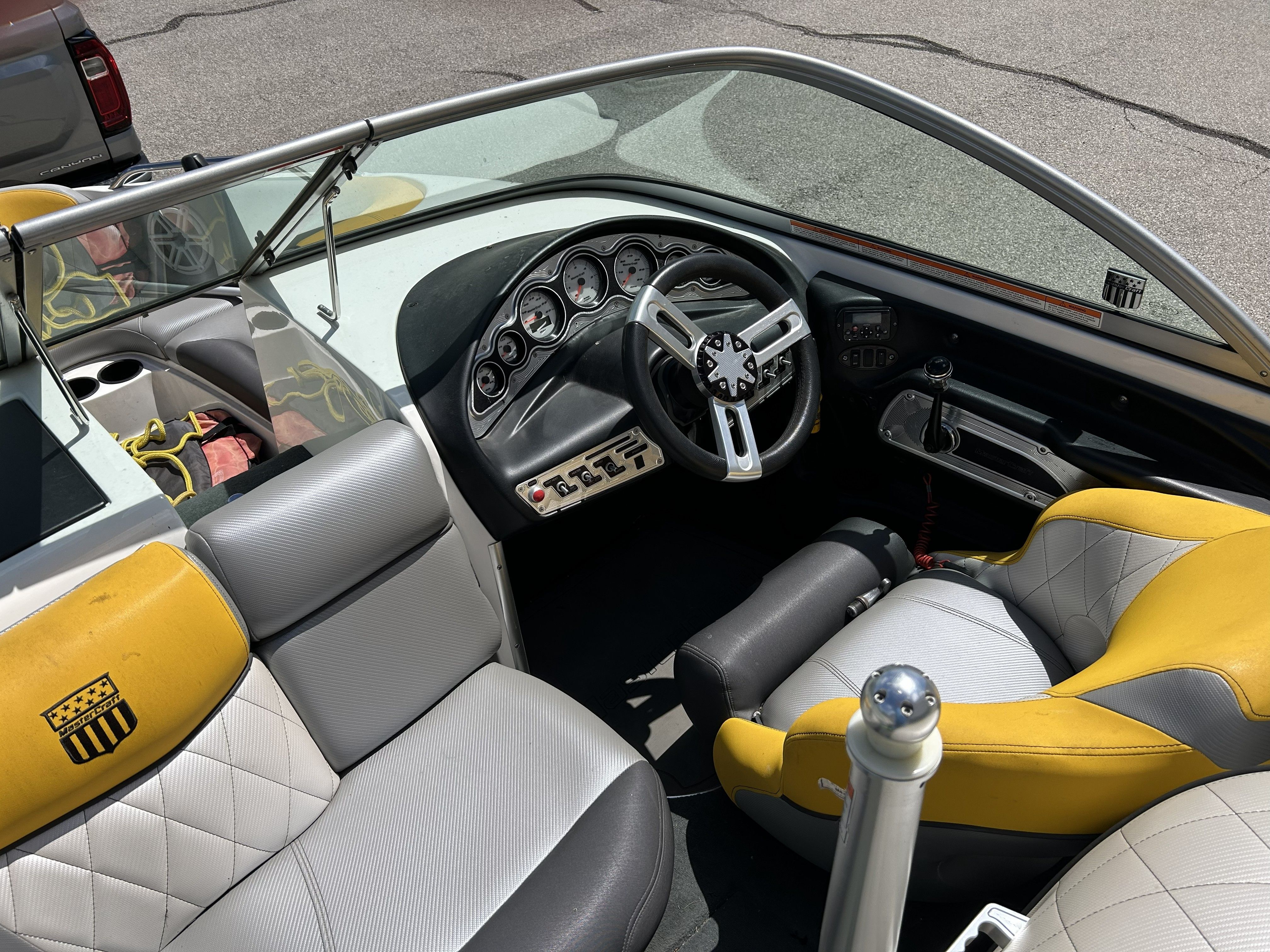 Interior of a 2011 MasterCraft PS197 boat with yellow and gray seats.